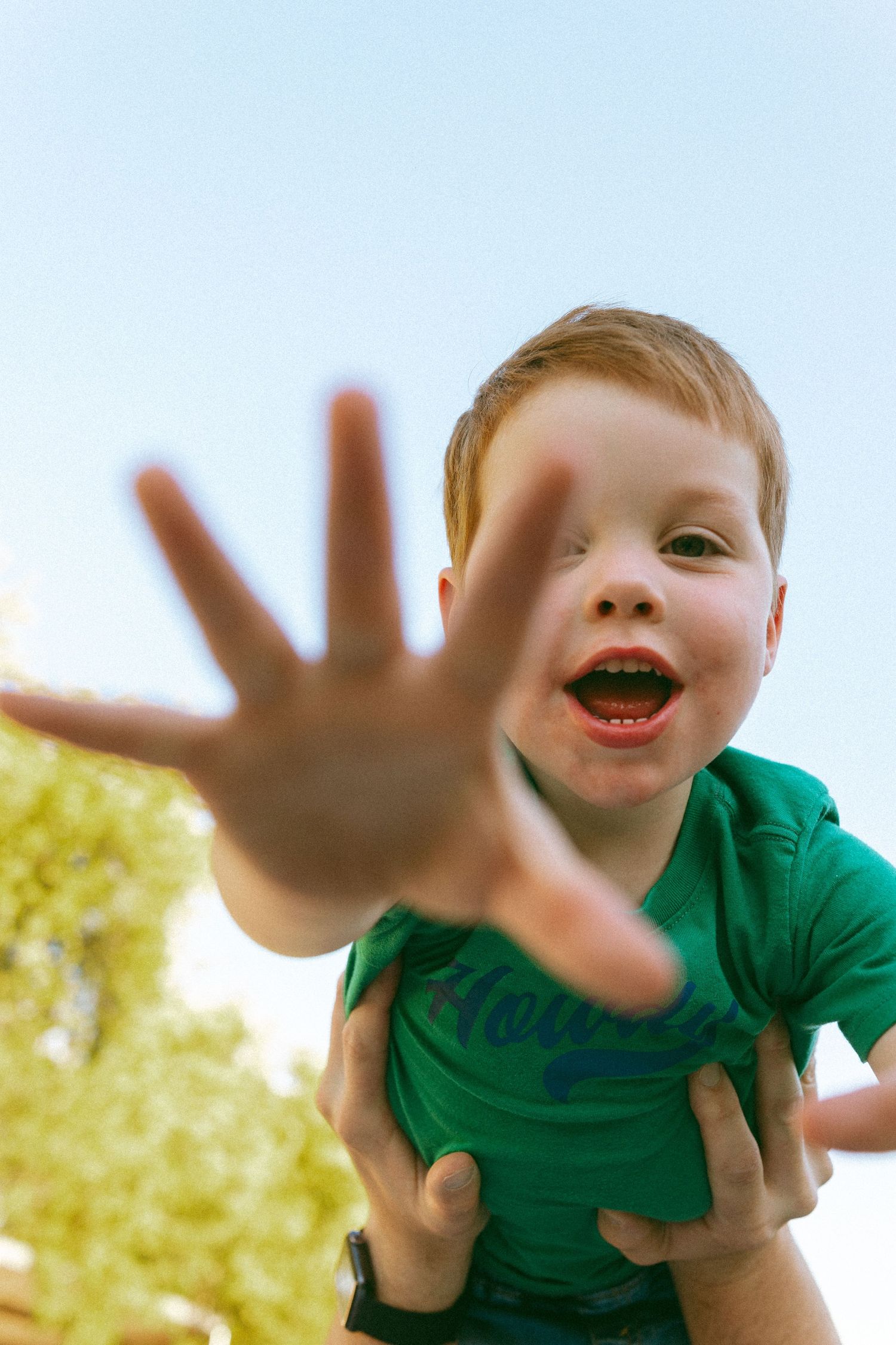 child reaching for the camera