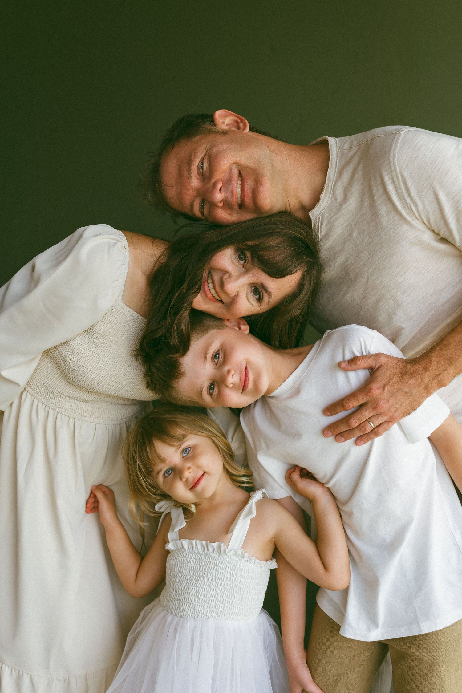 family stacking their heads on top of each other's during a lifestyle session