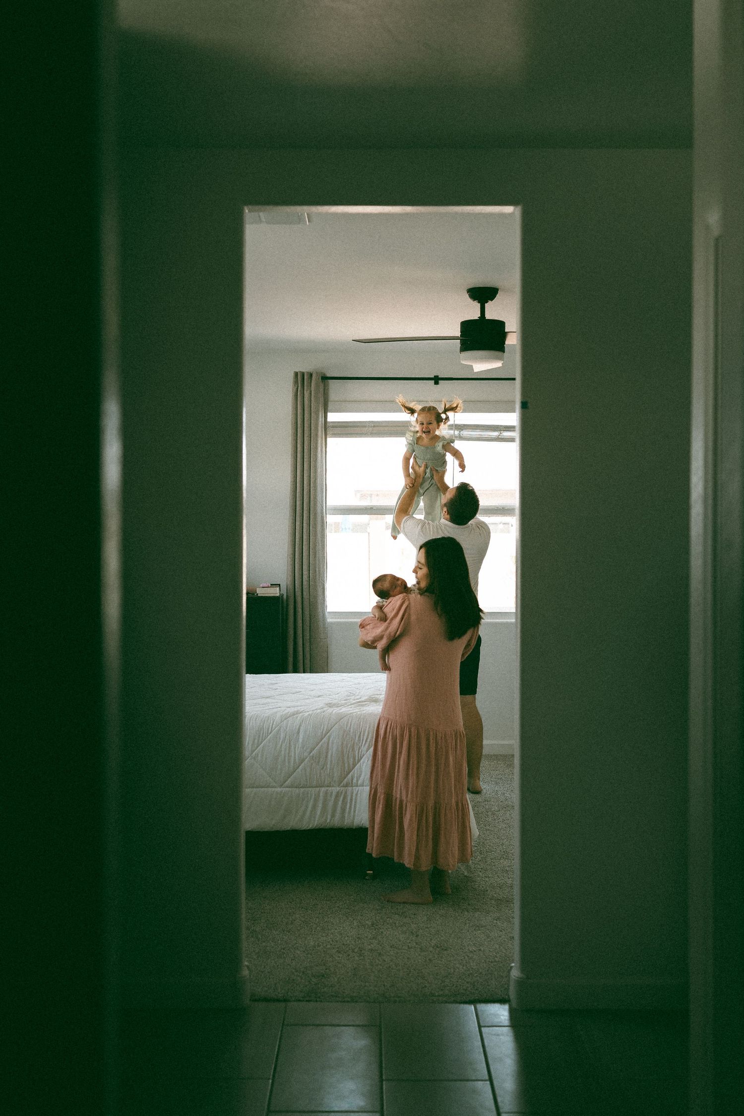 family playing with toddler and newborn during a lifestyle session