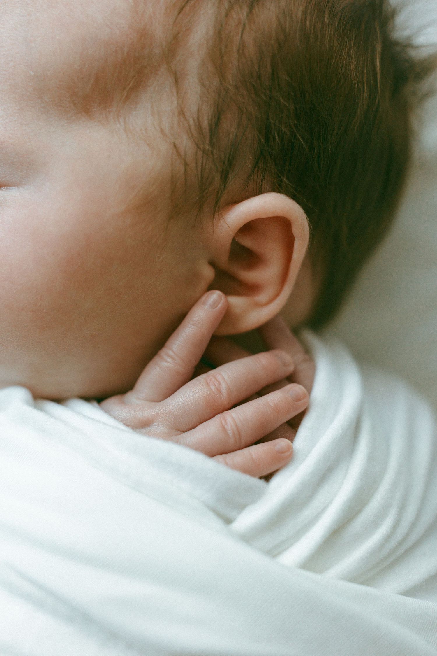 newborn baby hands and ear