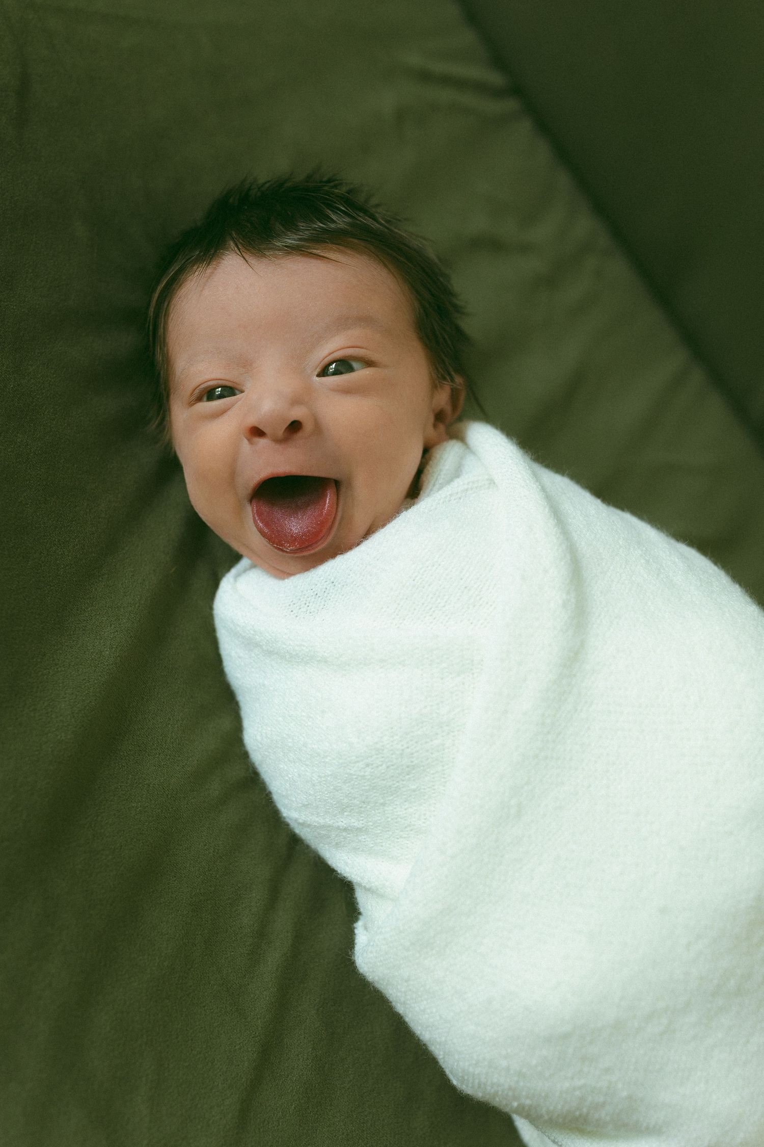 newborn smiling at camera during a newborn session