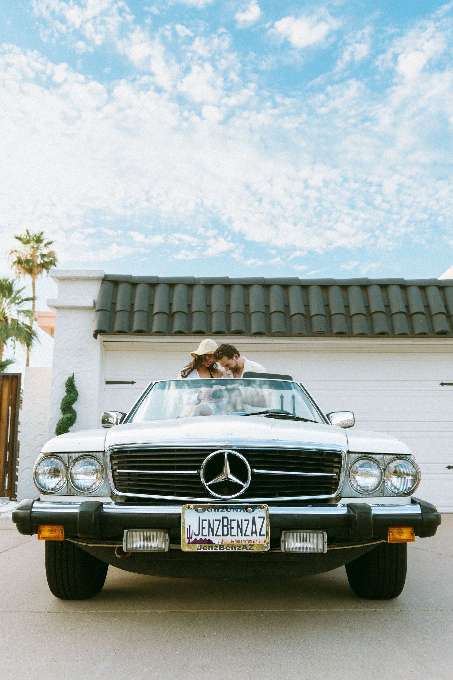family posing in a vintage car