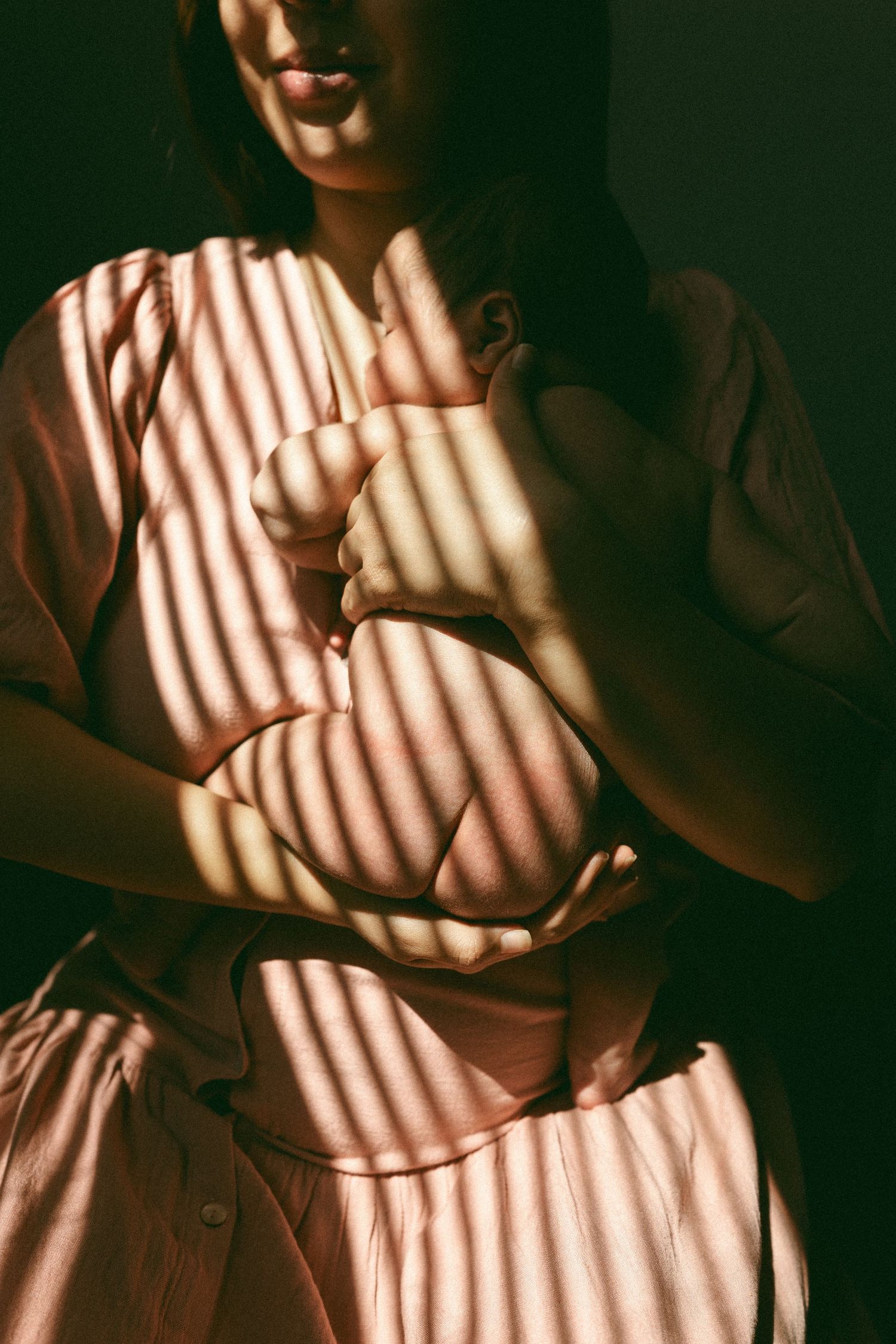 mother holding a newborn baby during a lifestyle session