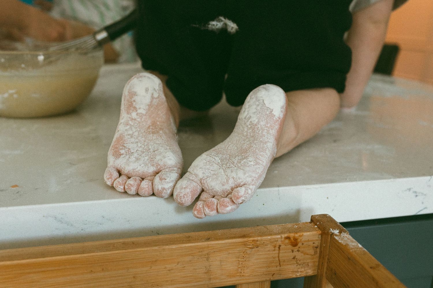 Childs feet covered in flour during a lifestyle session