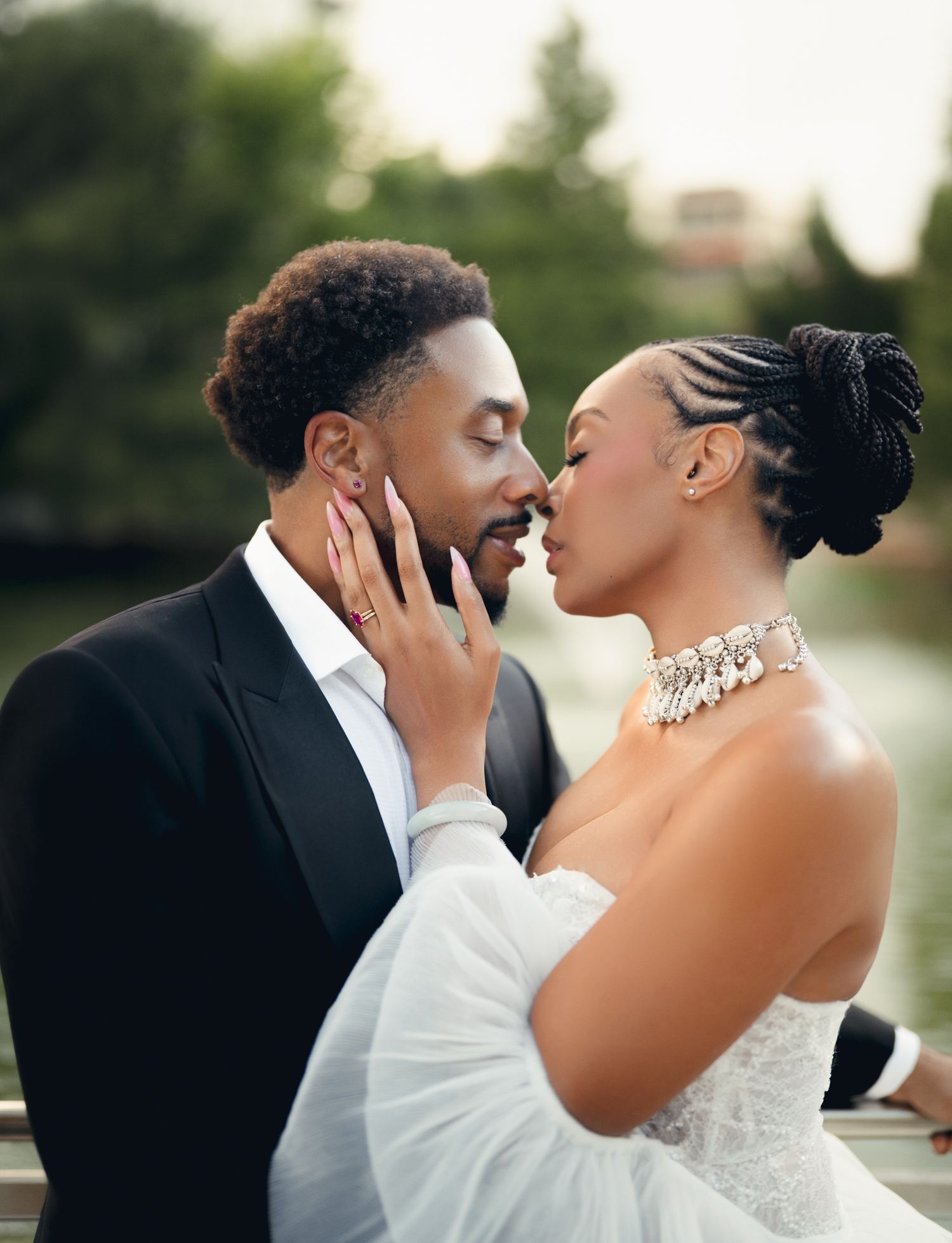 Atlanta wedding photography of a bride and groom sharing a romantic moment outdoors near the water.