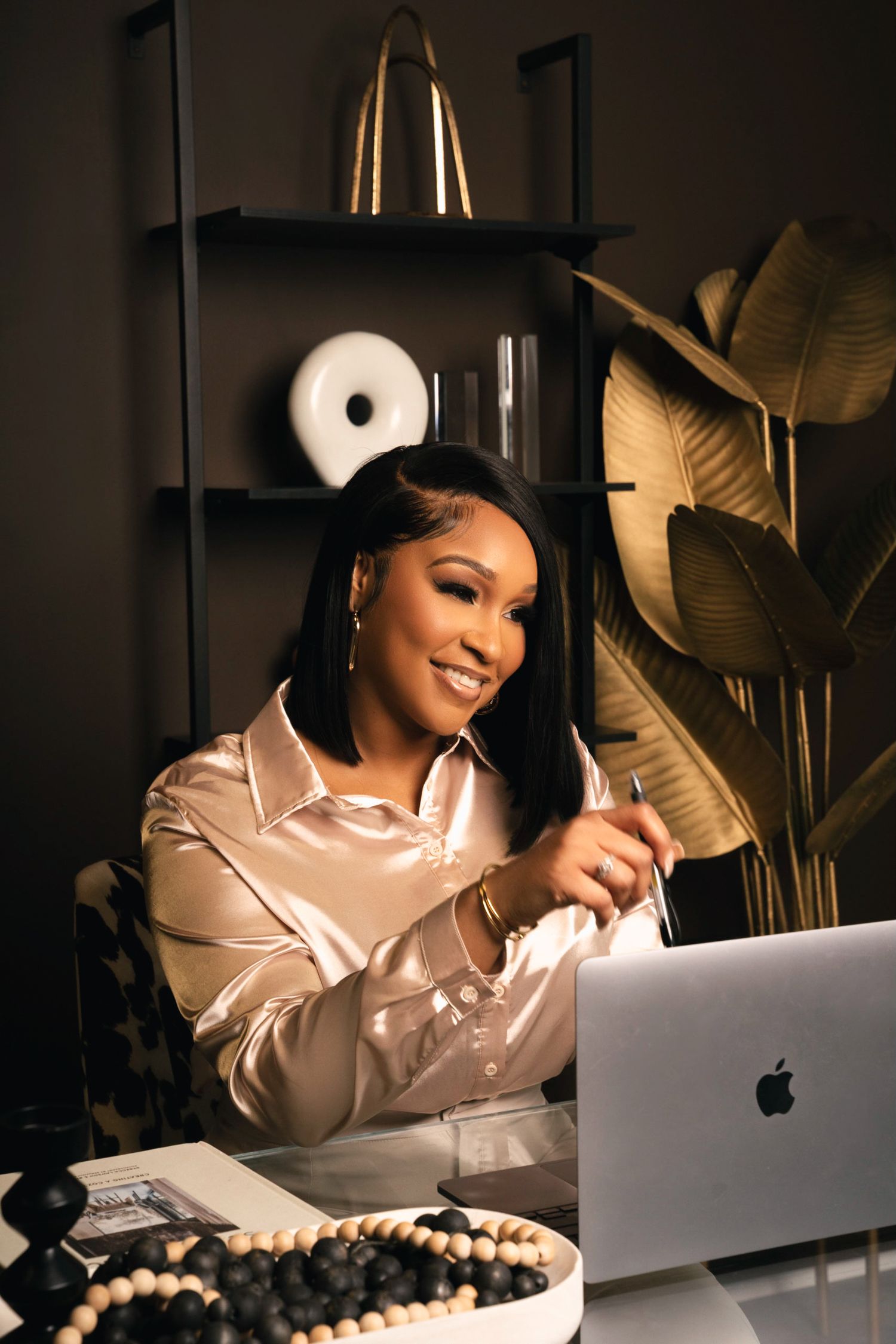 Atlanta business branding photography of a woman working on a laptop in a stylish office setting.