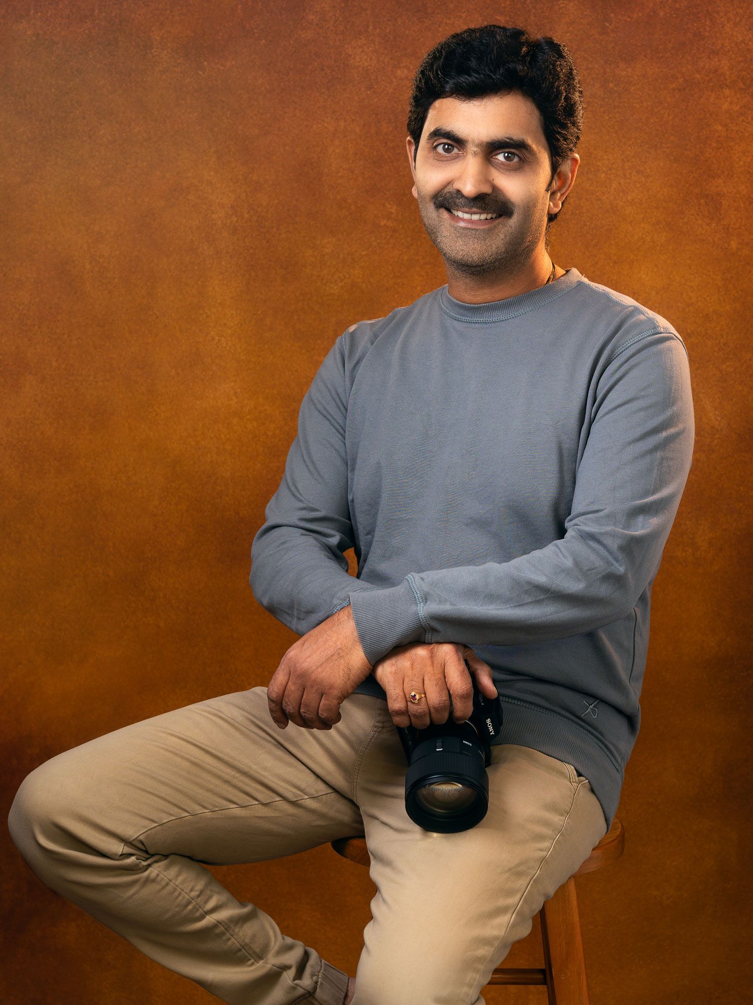 Portrait of Sasi Harsha sitting on a chair, wedding photographer based in Wellington, New Zealand