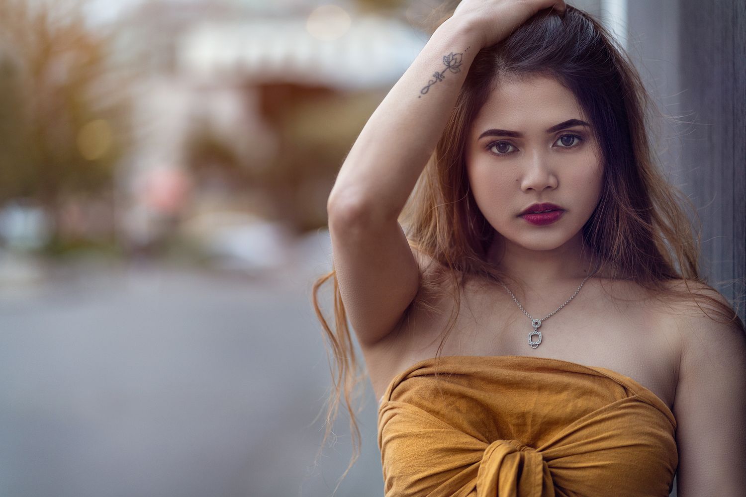 Dramatic portrait series featuring golden tones and urban backgrounds.