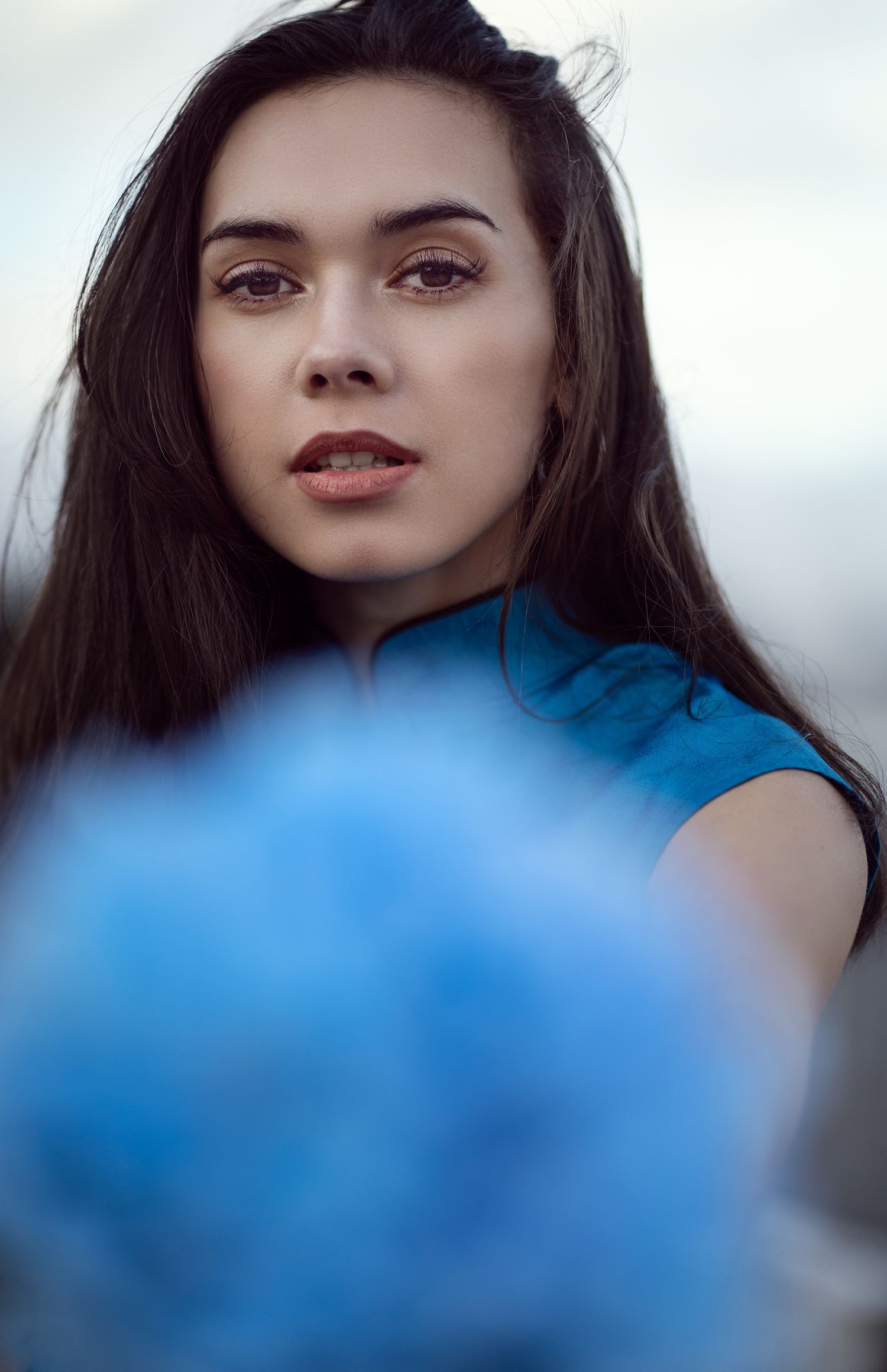 Artistic portrait series with blue tinted lighting and soft focus effects.