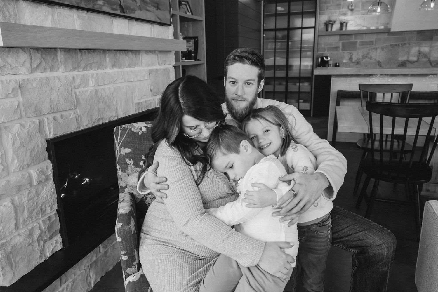 A black and white photo collage shows tender moments between a parent and sleeping child in various settings.