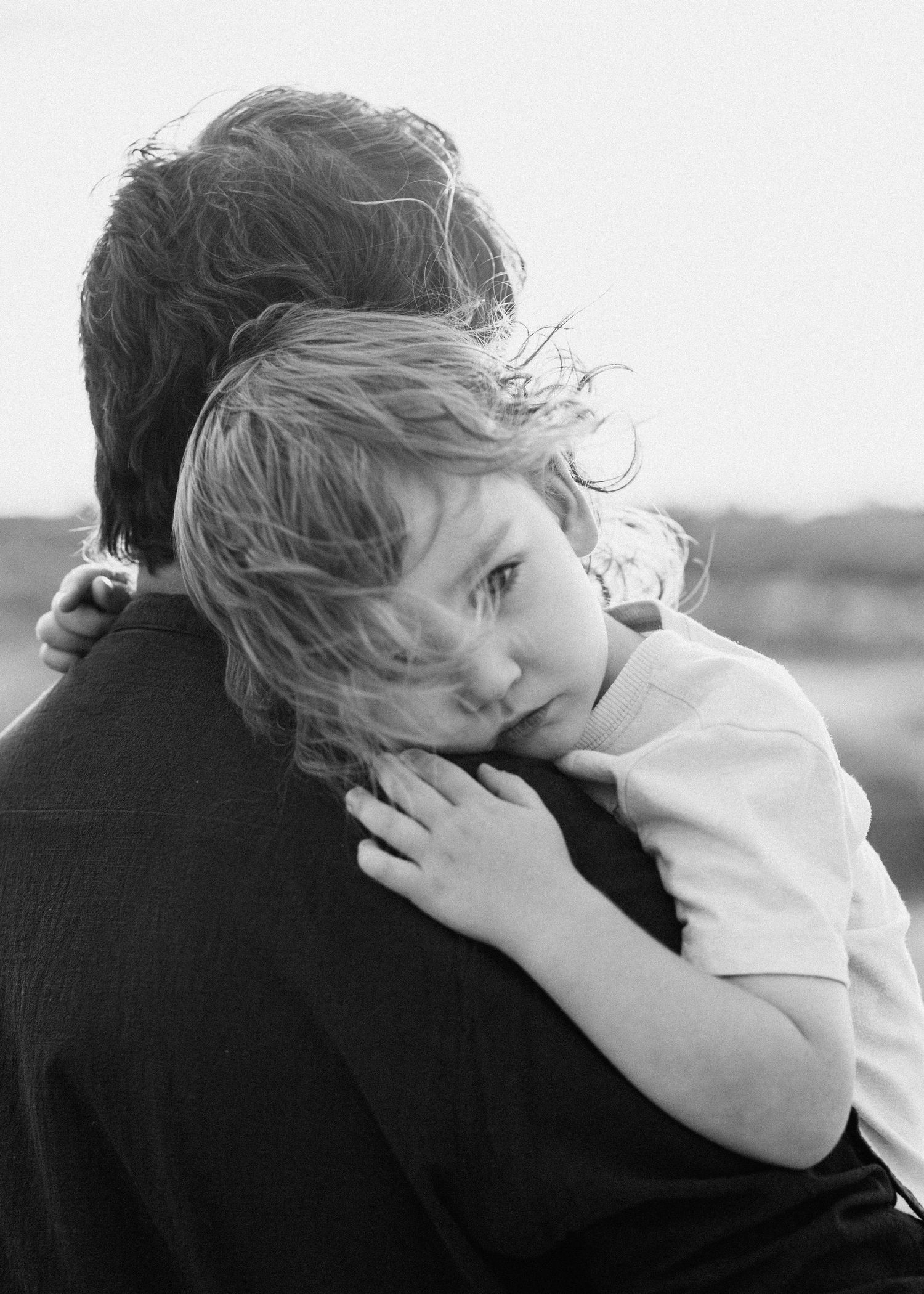 Black and white series showing intimate family embrace.