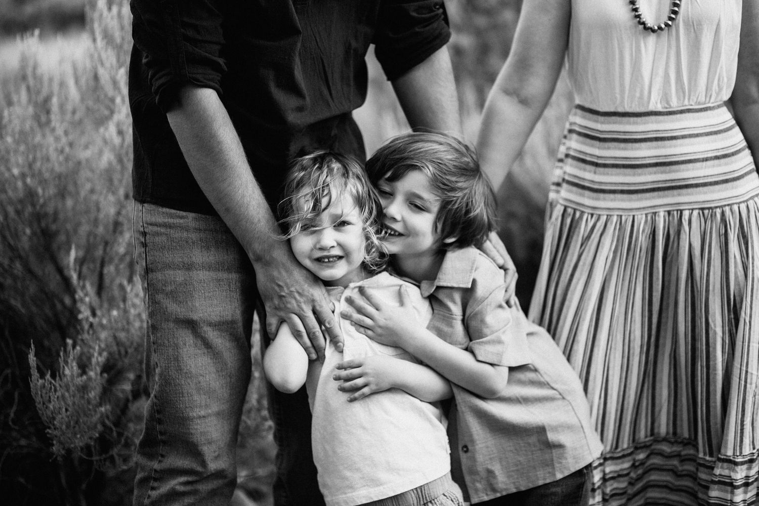 Candid family moments captured during outdoor photo session.