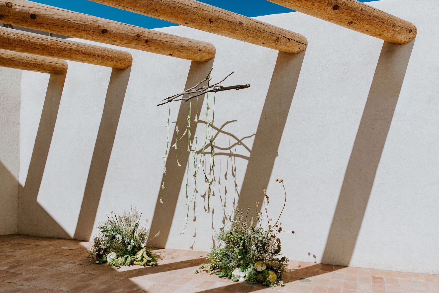 Rustic viga beams and white walls at Hotel Willa in Taos, New Mexico, captured in an architectural detail photograph.