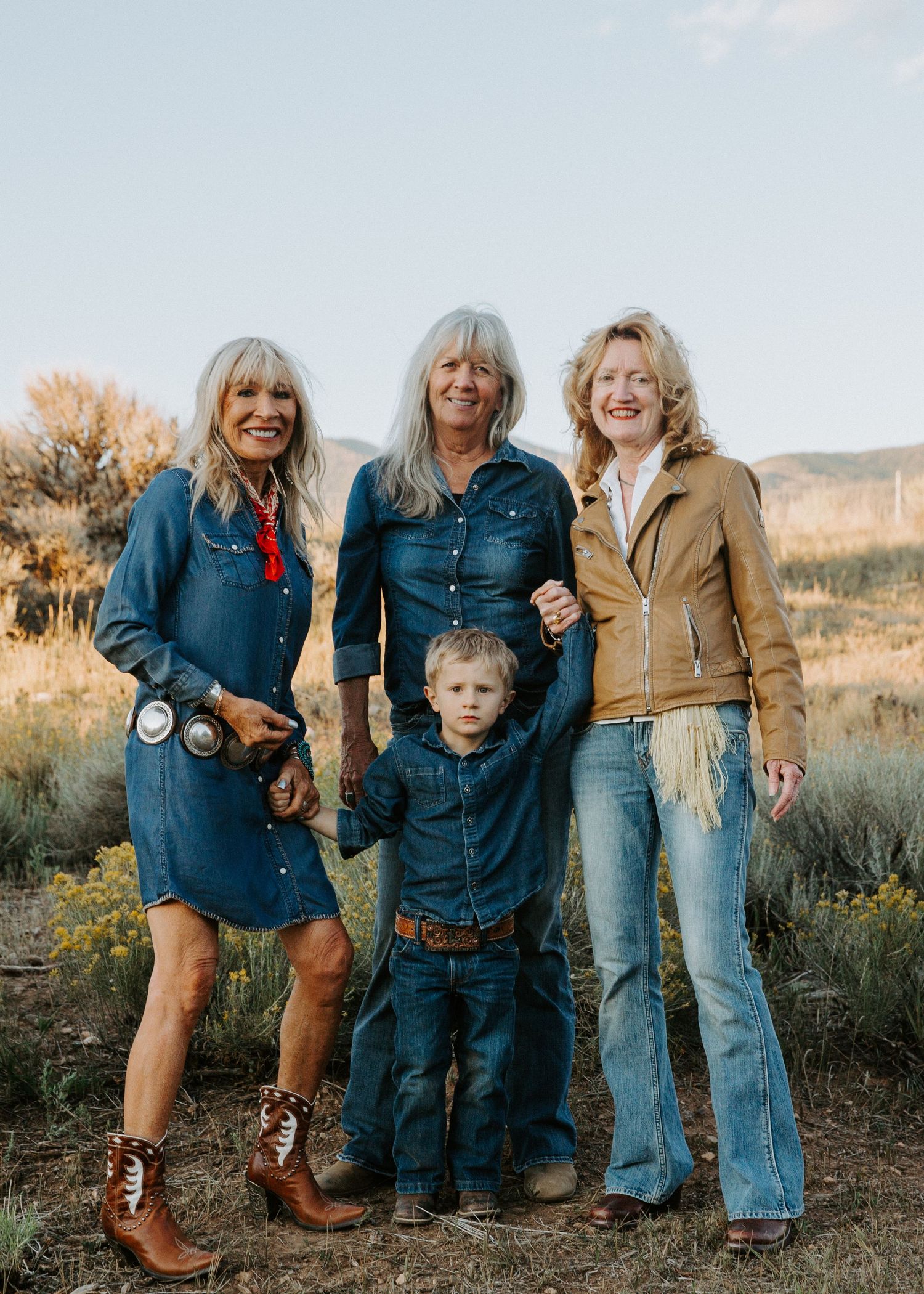 Generational portrait session in Taos New Mexico with group styled in western attire during golden hour in desert landscape
