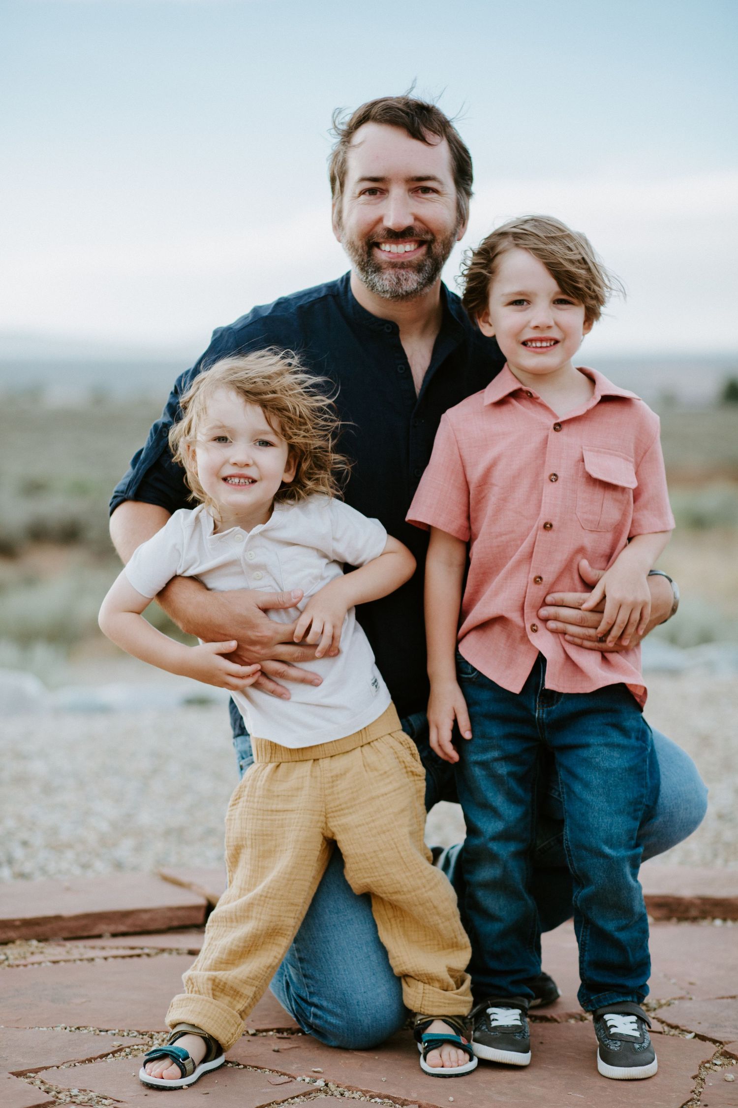 A sequence of joyful outdoor family moments captured against a natural landscape backdrop.