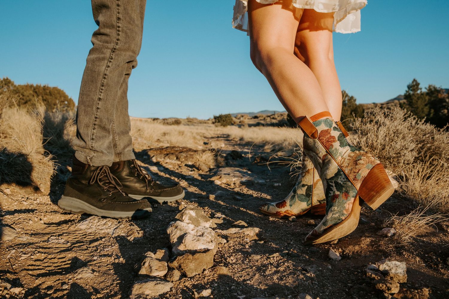 Close-up of couple’s hiking boots during an adventurous engagement session in Taos, New Mexico