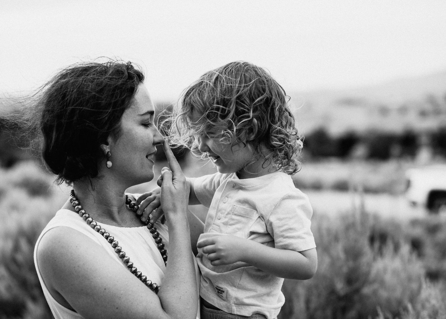 Black and white intimate family portrait series showing tender moments.