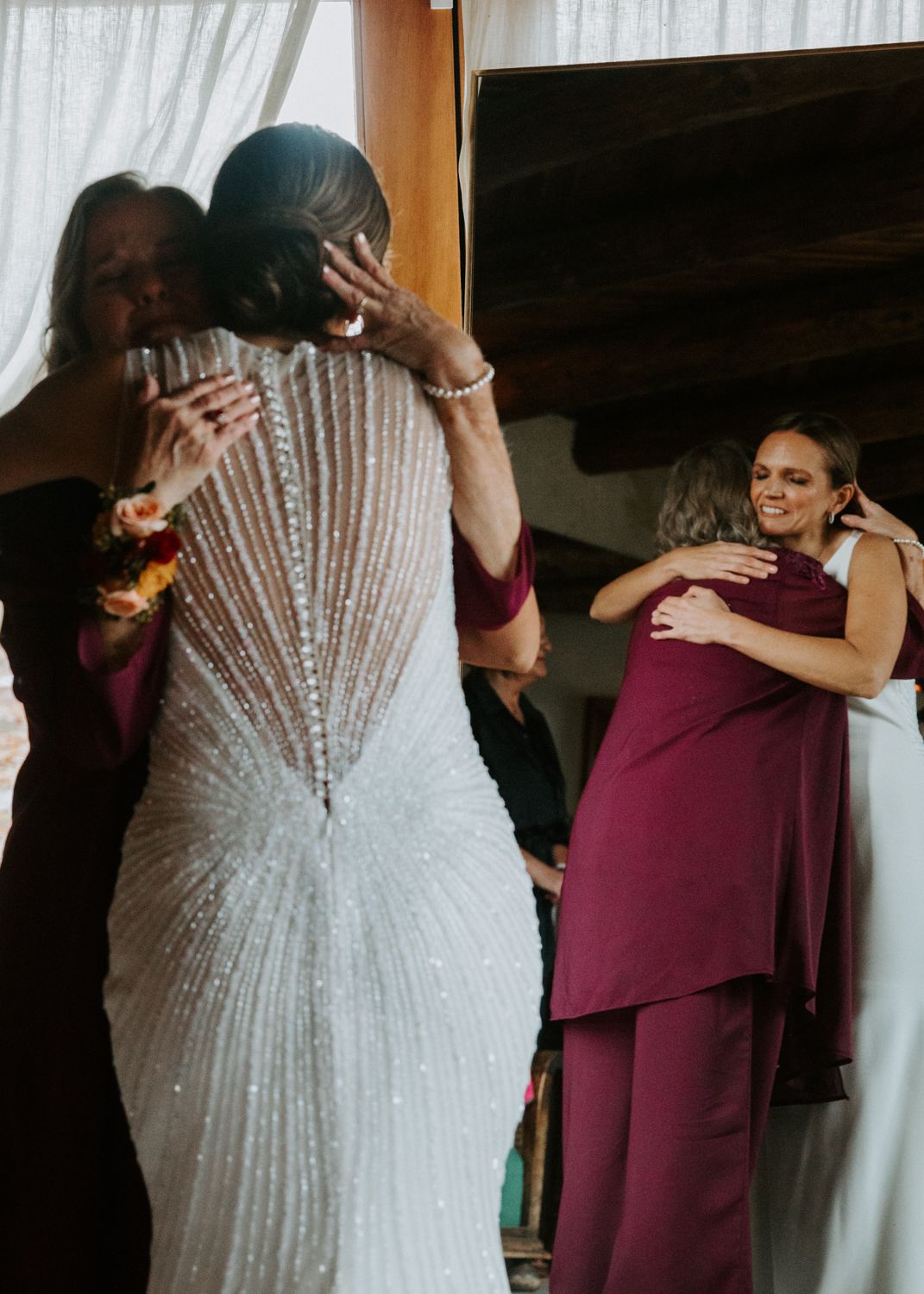 Wedding dress detail showing intricate beading and sequin pattern in white.