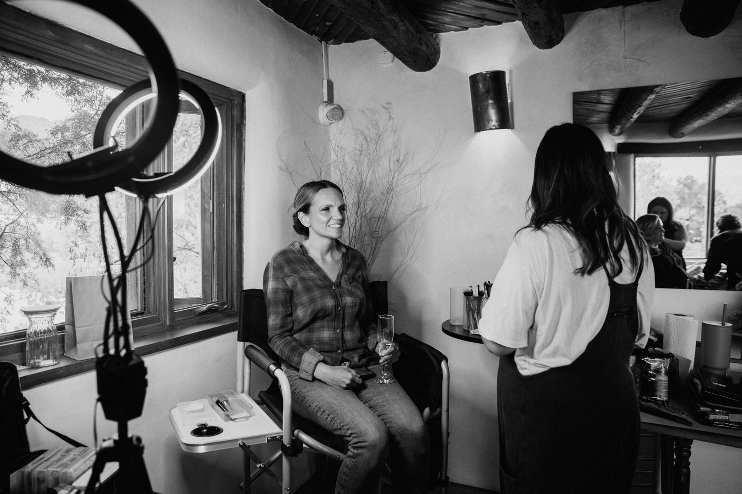 Black and white interior shots of a rustic room with wooden beams and natural light.