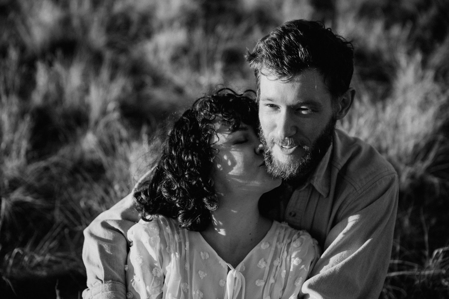 Black and white engagement session in Taos NM with couple sharing a quiet, intimate moment outdoors