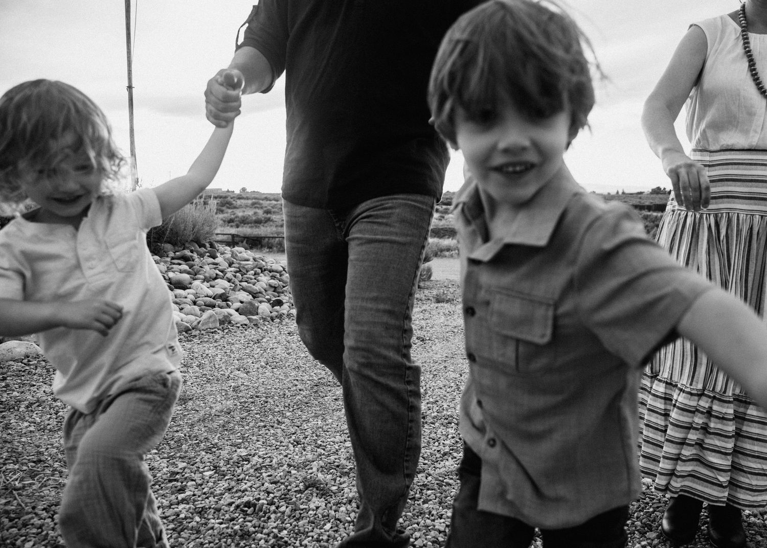Series of black and white candid shots showing family playing outdoors.