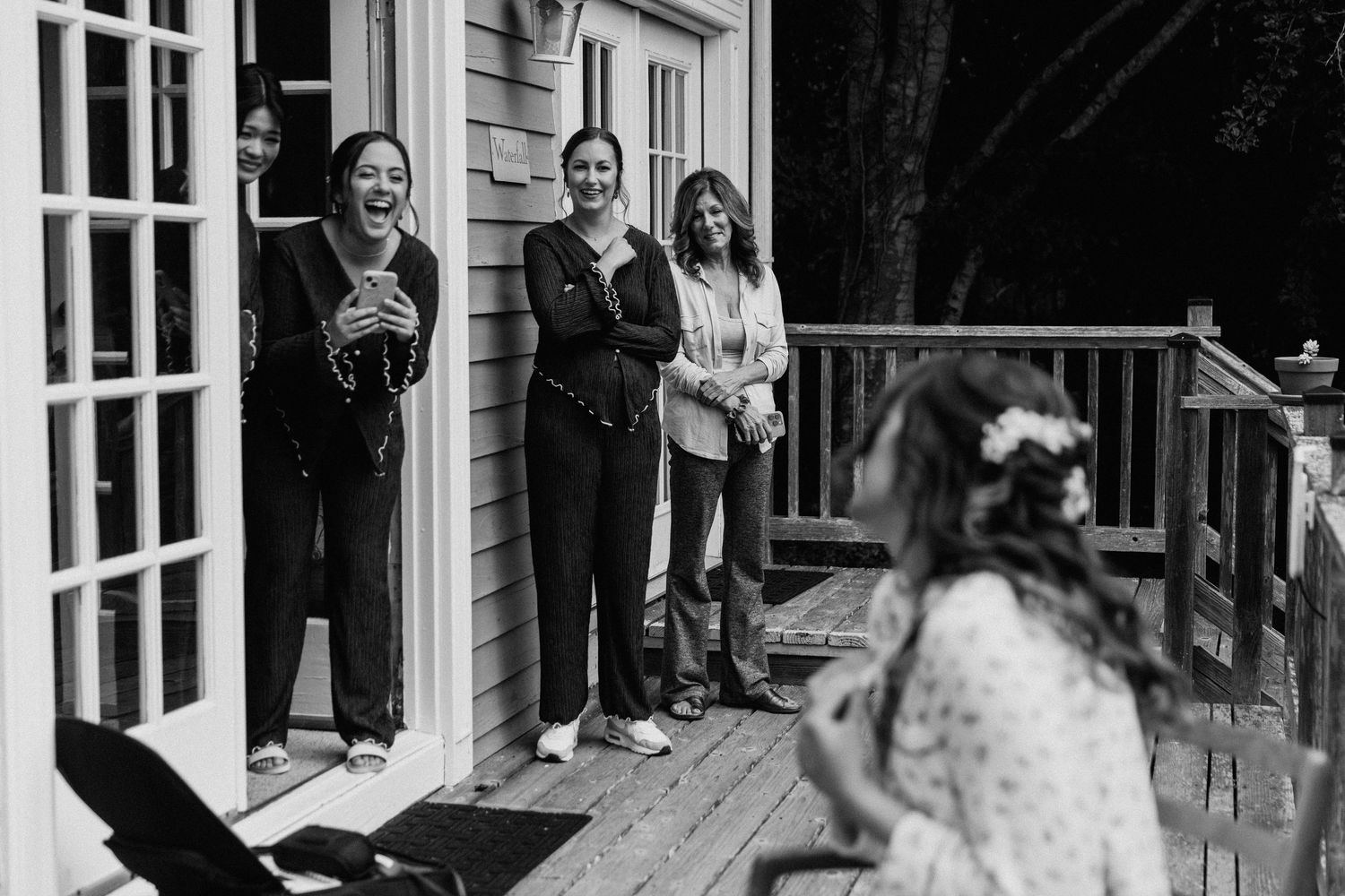 A candid moment captured on a white porch during a celebration.