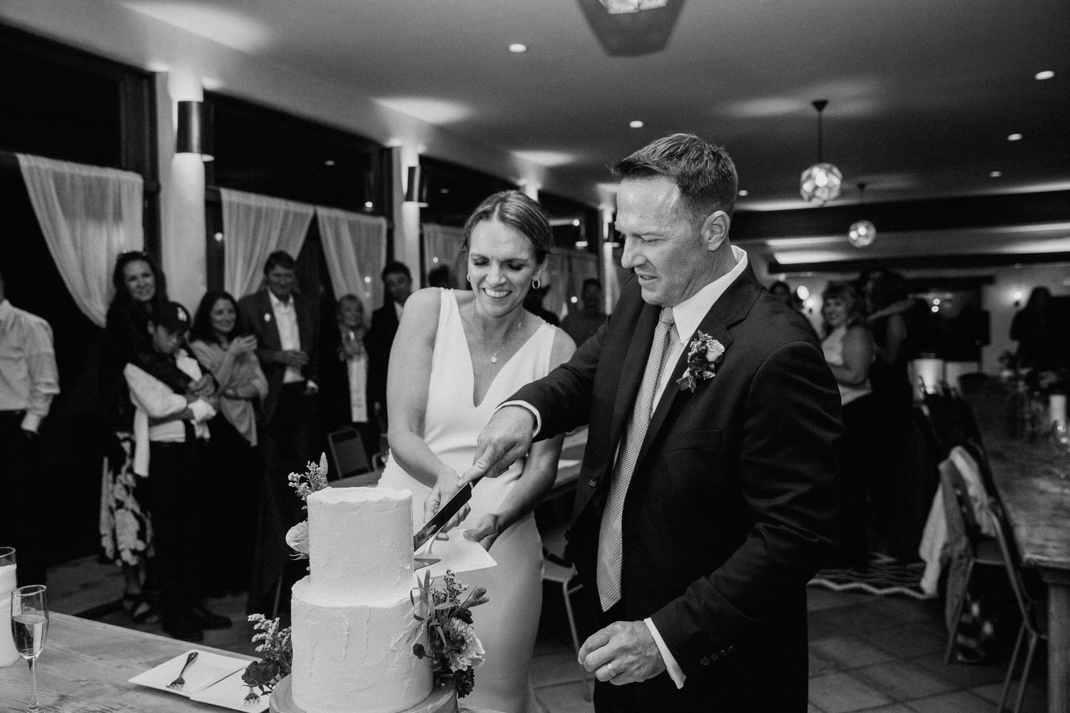 Black and white wedding reception photos showing dancing, dining, and celebration moments at an elegant indoor venue.