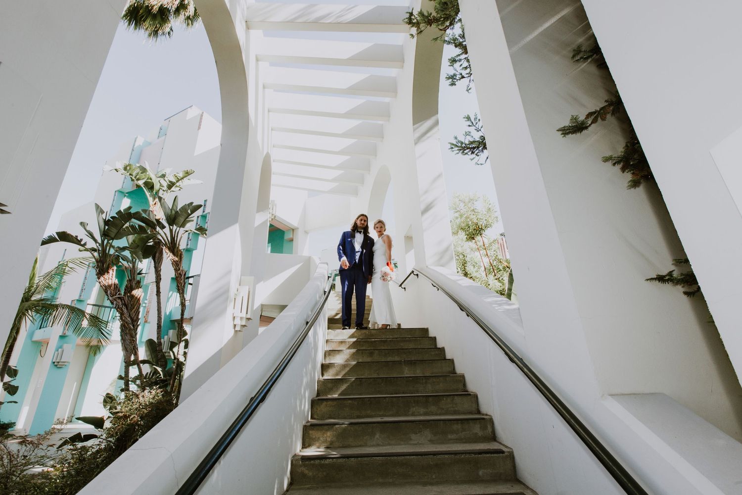 Bright interior hallway with white columns and dramatic shadow patterns.  Shot in California, by Siouxzen Kang