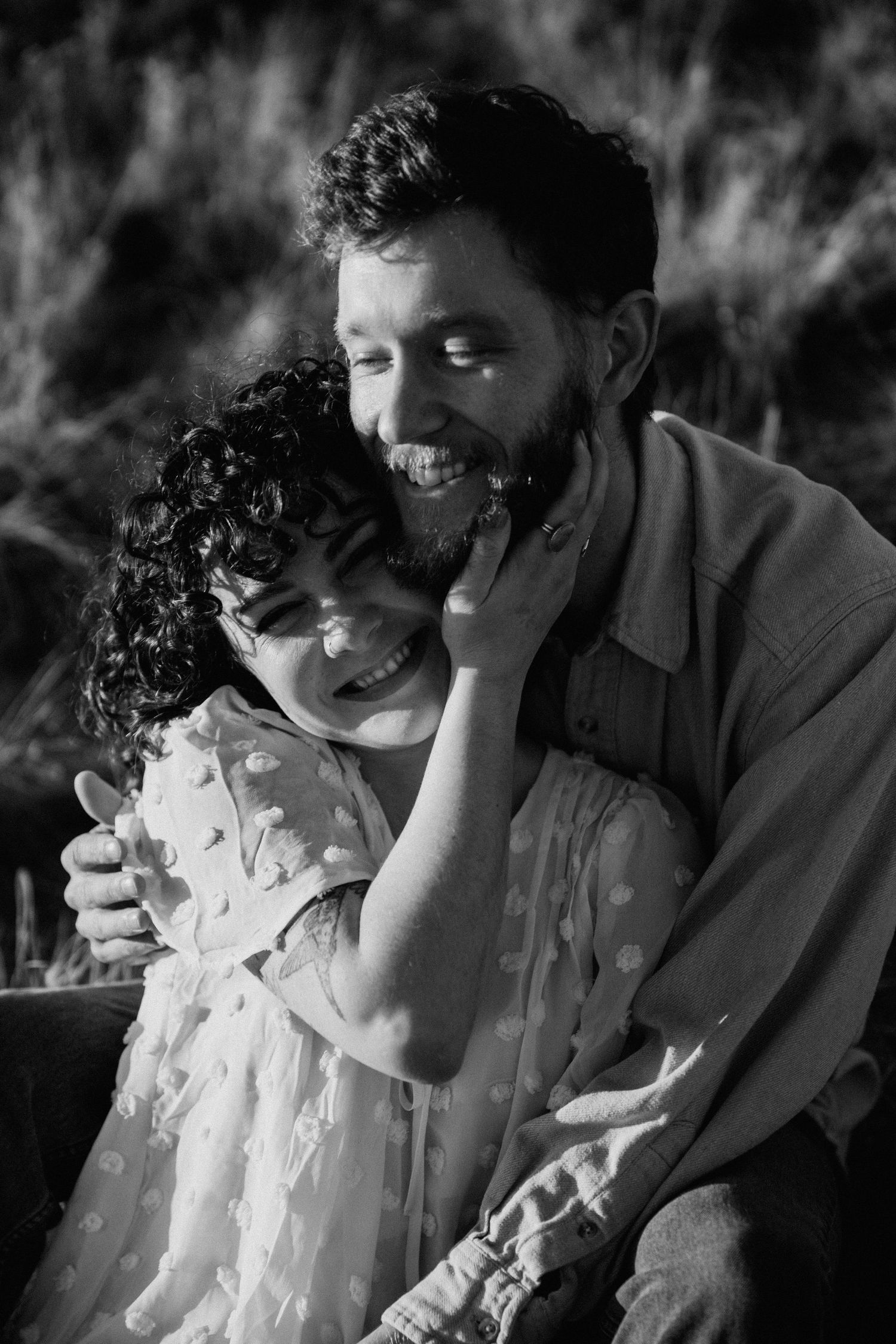 Black and white engagement session in Taos, New Mexico capturing candid laughter and intimate moments between a couple