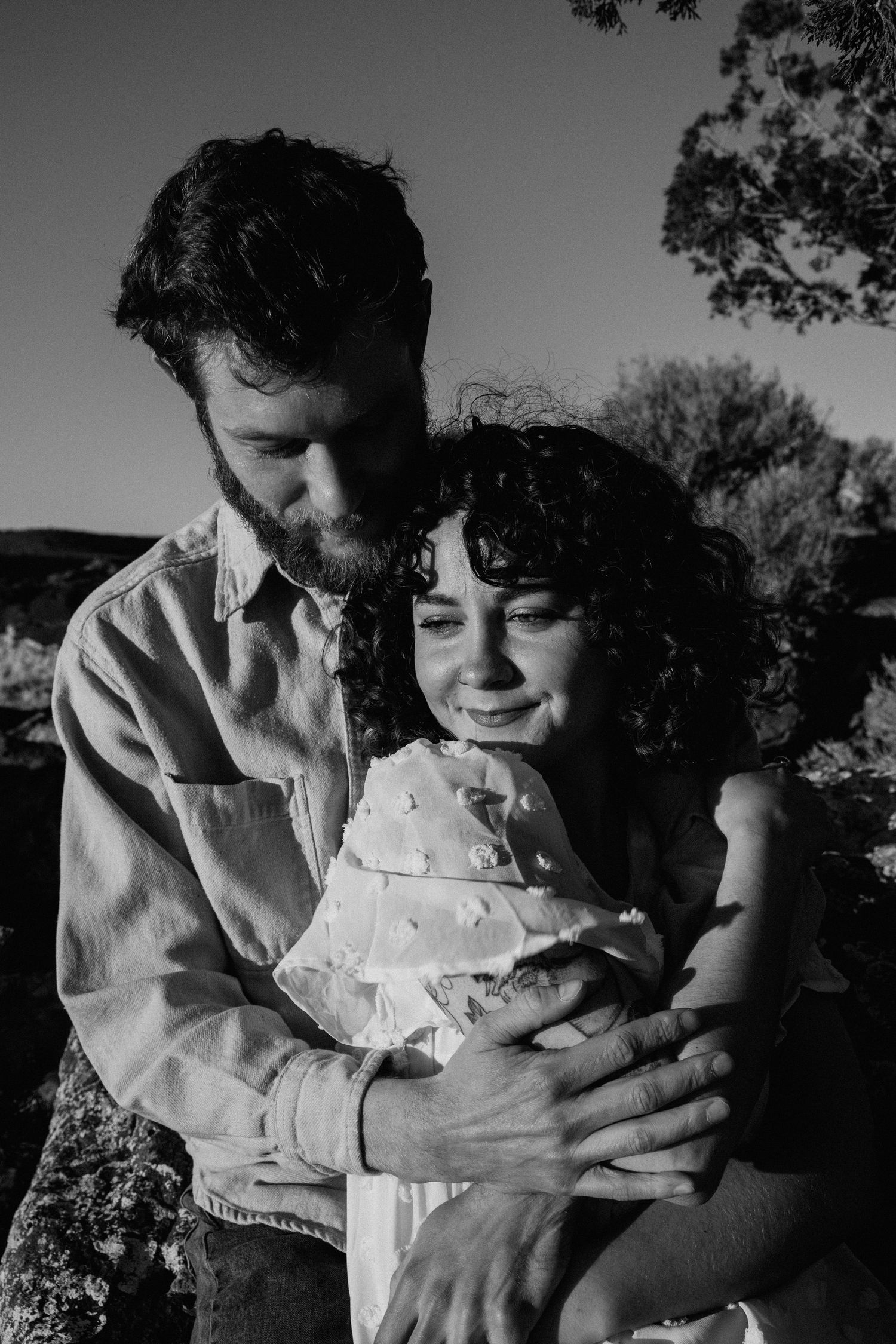 Black and white engagement portrait in Taos NM capturing an intimate moment between a couple outdoors