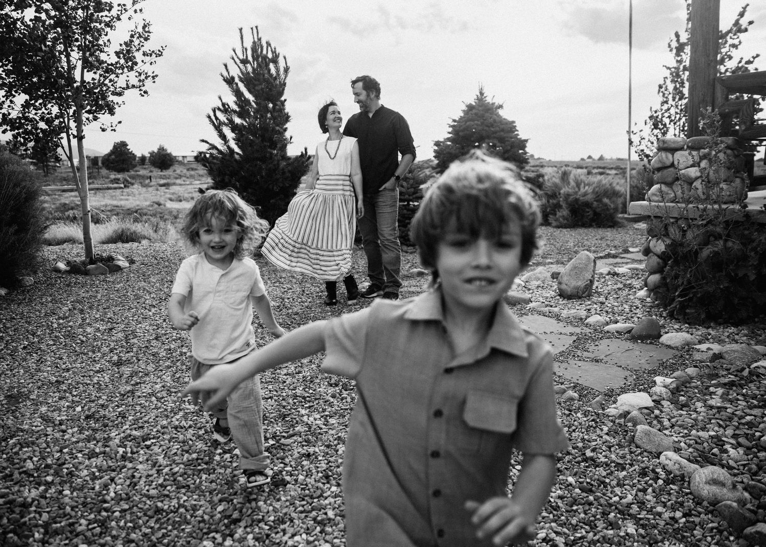 A playful series of black and white photos capturing joyful moments outdoors.