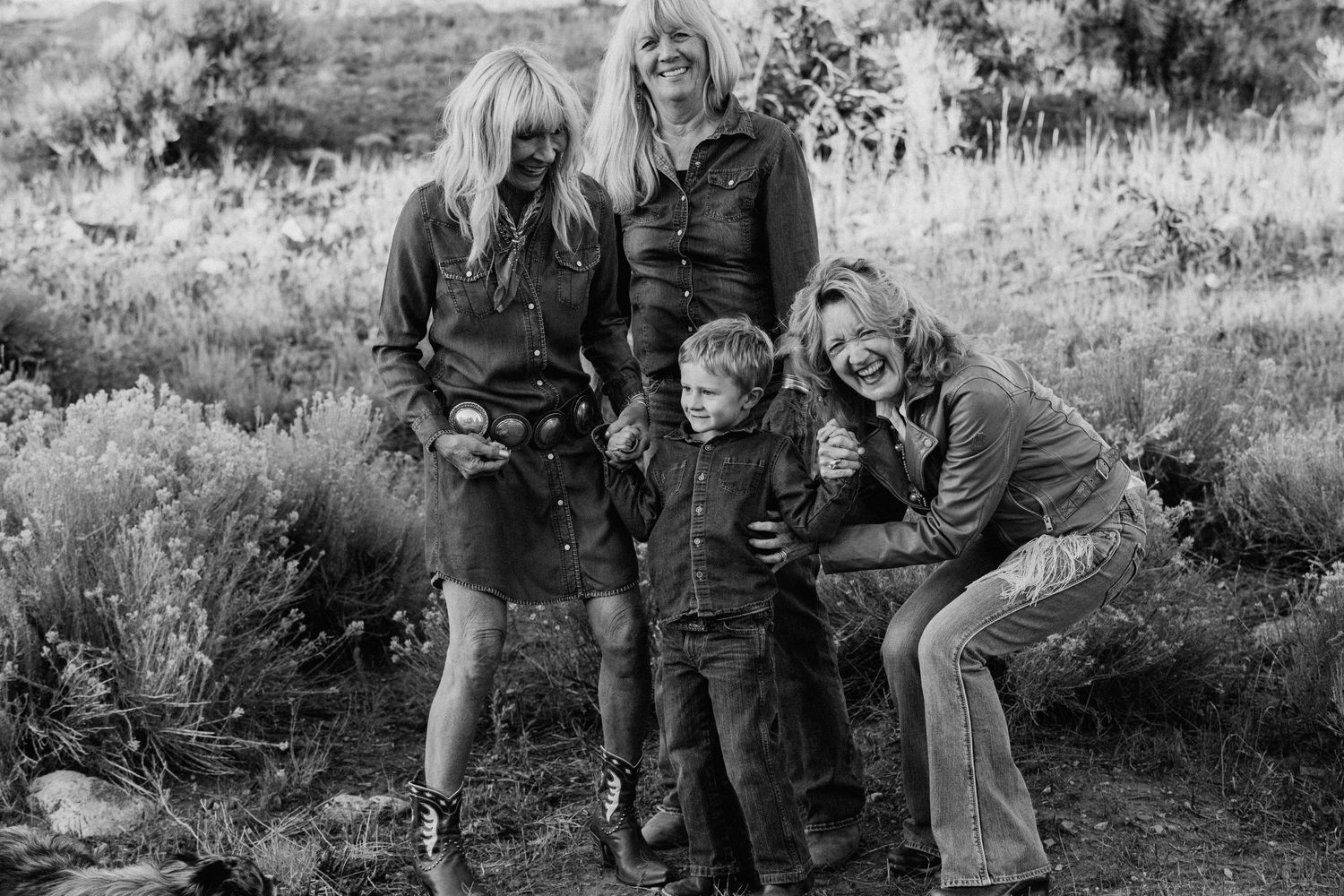 Black and white family portrait session in Taos New Mexico with group gathered outdoors in natural landscape