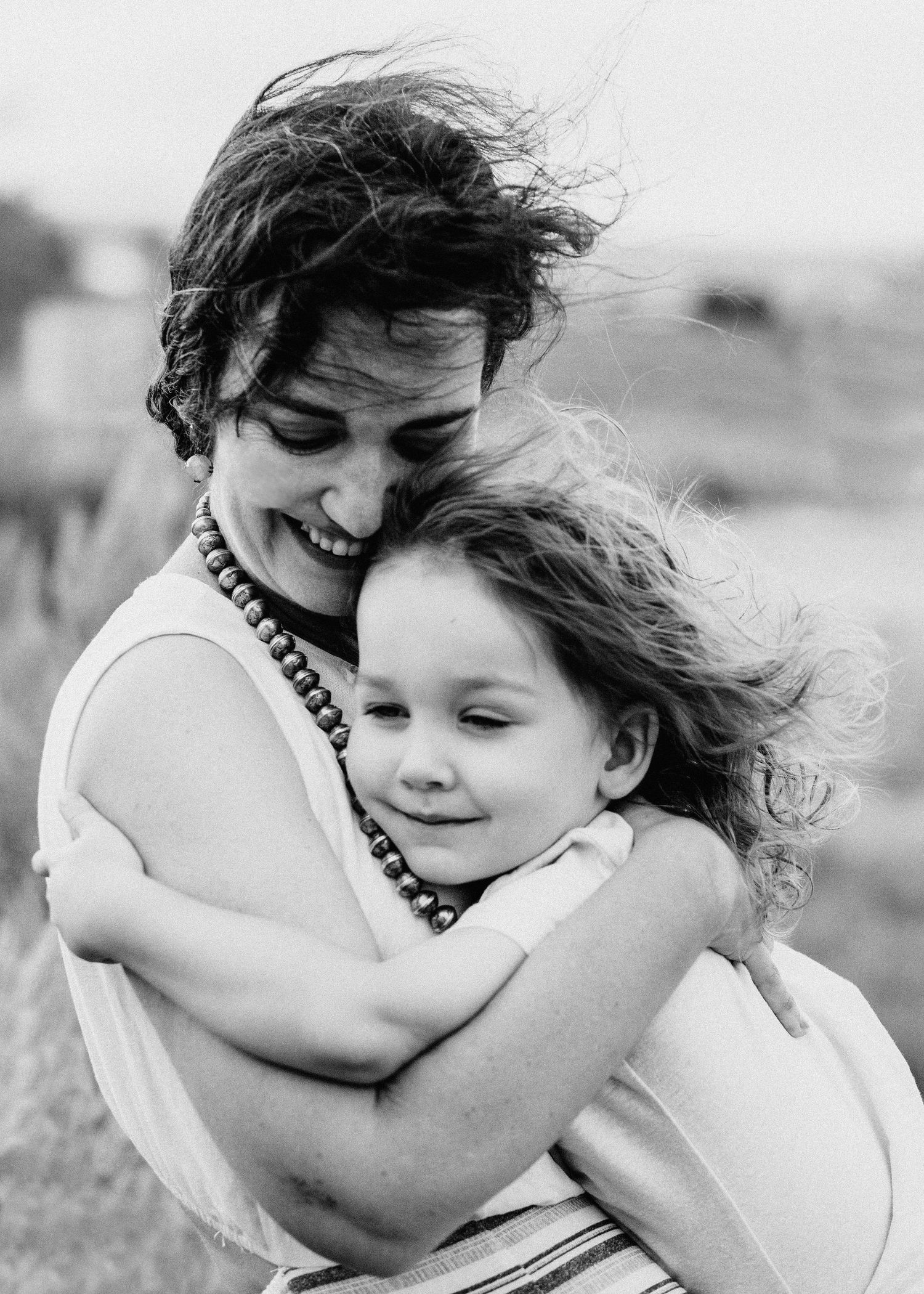 Black and white portrait of joyful embrace between family members.