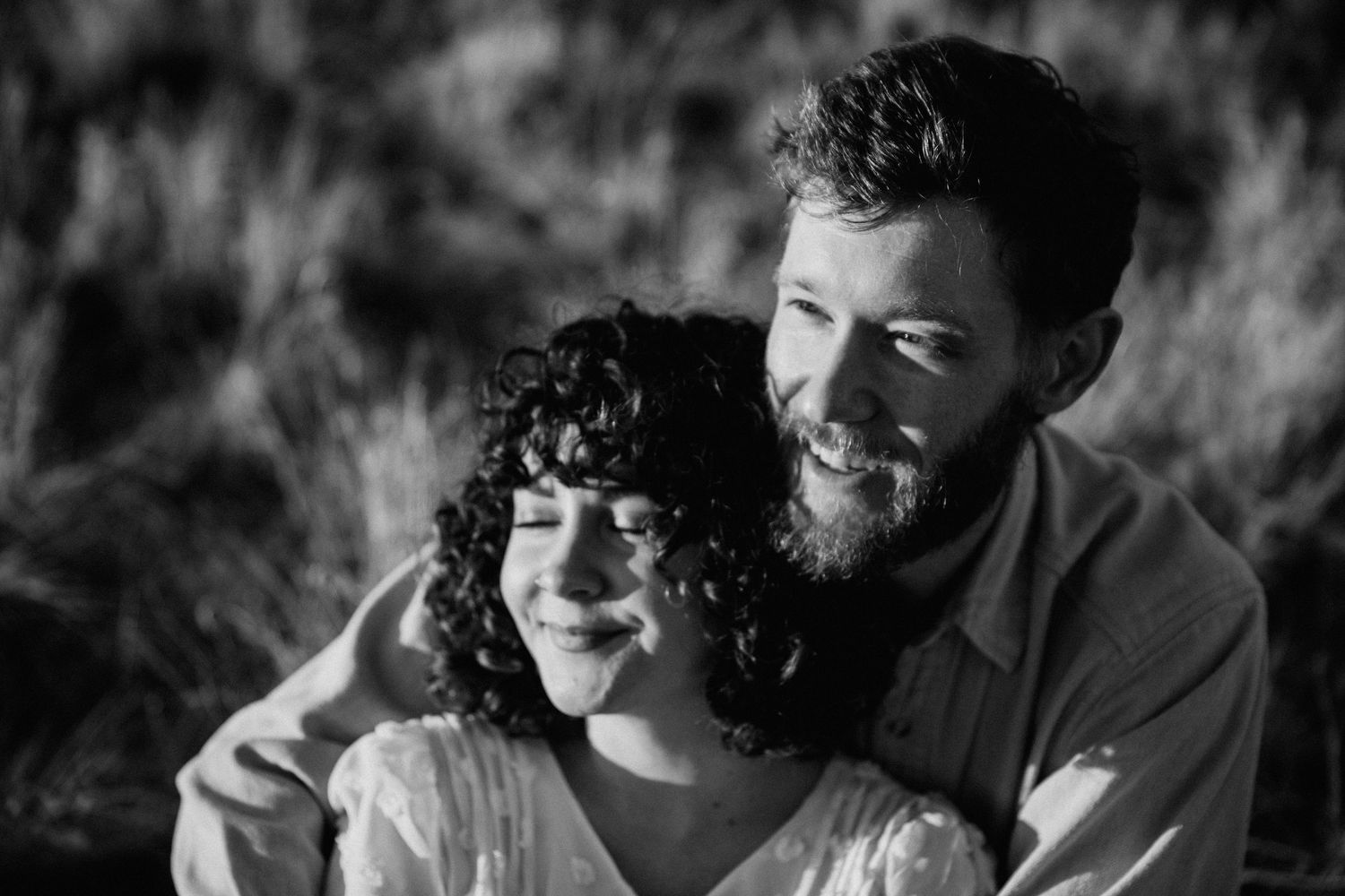 Candid black and white engagement session in Taos New Mexico capturing natural joy and connection between a couple