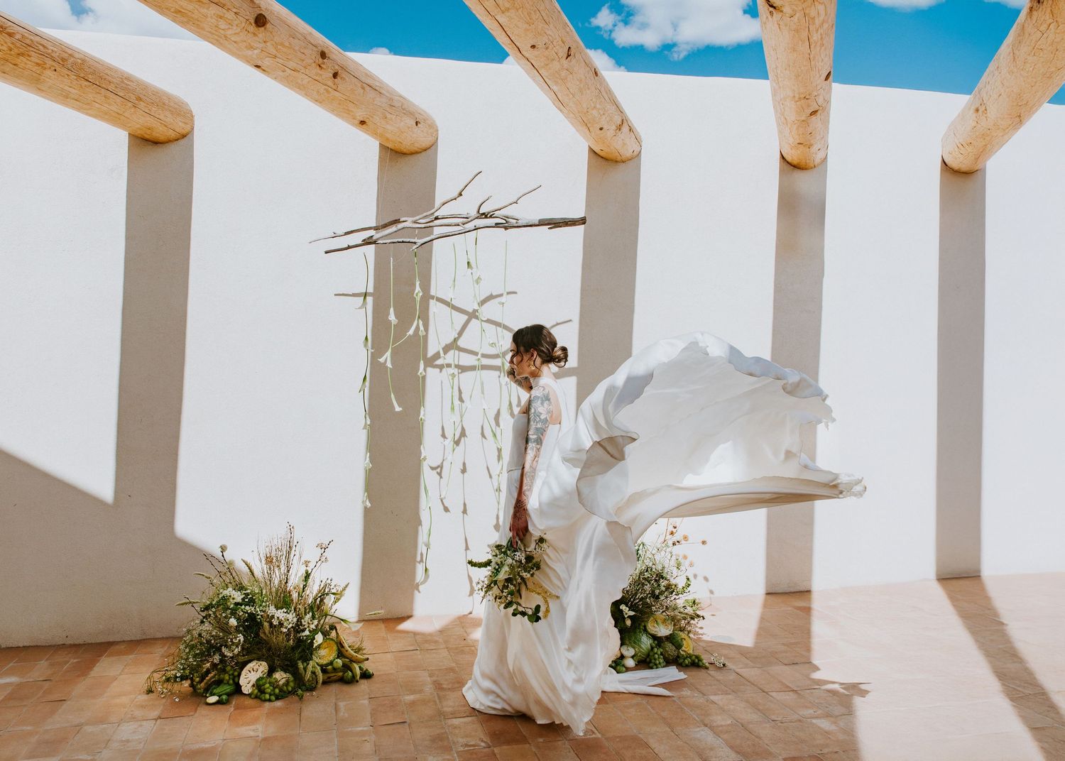 Modern architectural space with wooden beams casting dramatic shadows on white walls.  Shot in Taos, NM by Siouxzen Kang