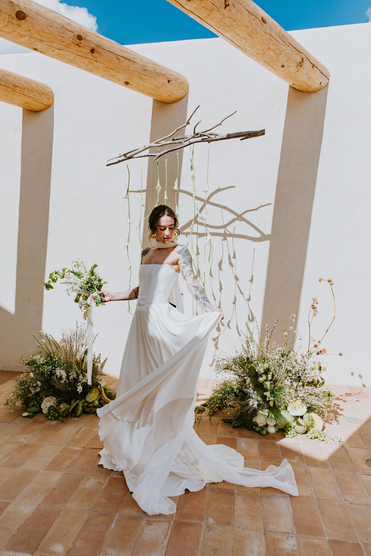 A sequence of artistic bridal photos showing flowing white dress movement against a rustic white and wood beam backdrop.