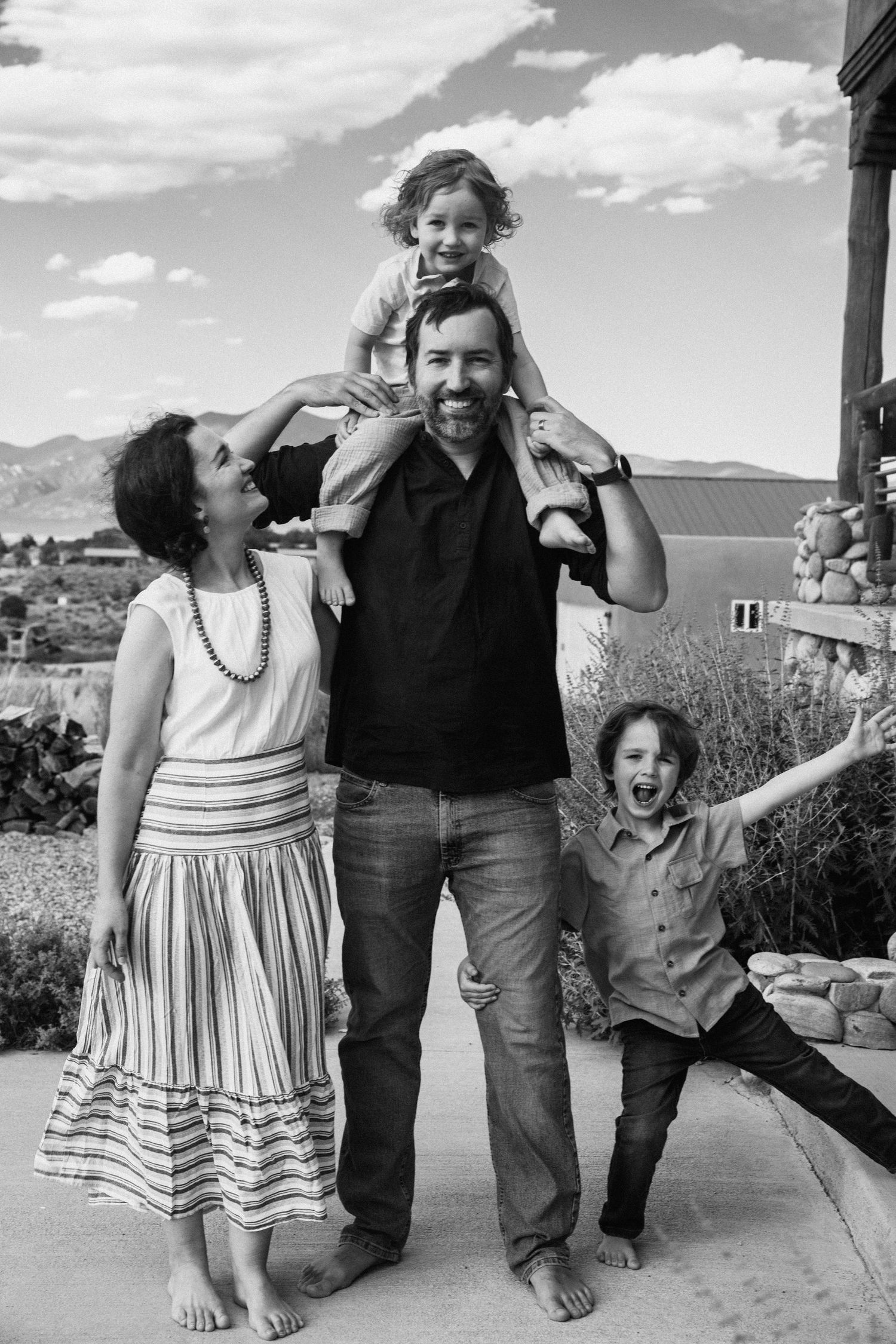A playful series of black and white photos showing joyful moments between family members outdoors.