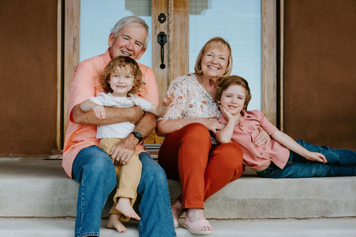 Casual family moments captured on concrete steps in warm natural lighting.