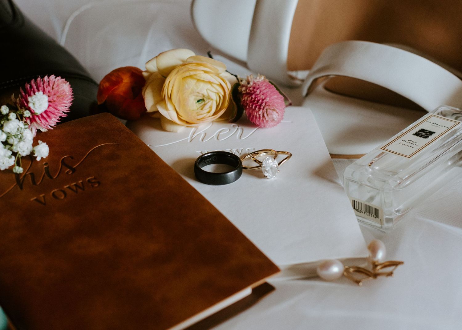 Elegant table setting with pink and cream roses alongside white decor elements.  Shot in California by Siouxzen Kang