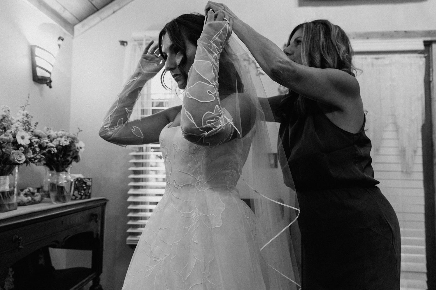 Black and white candid moments of a couple dancing together at a wedding reception.