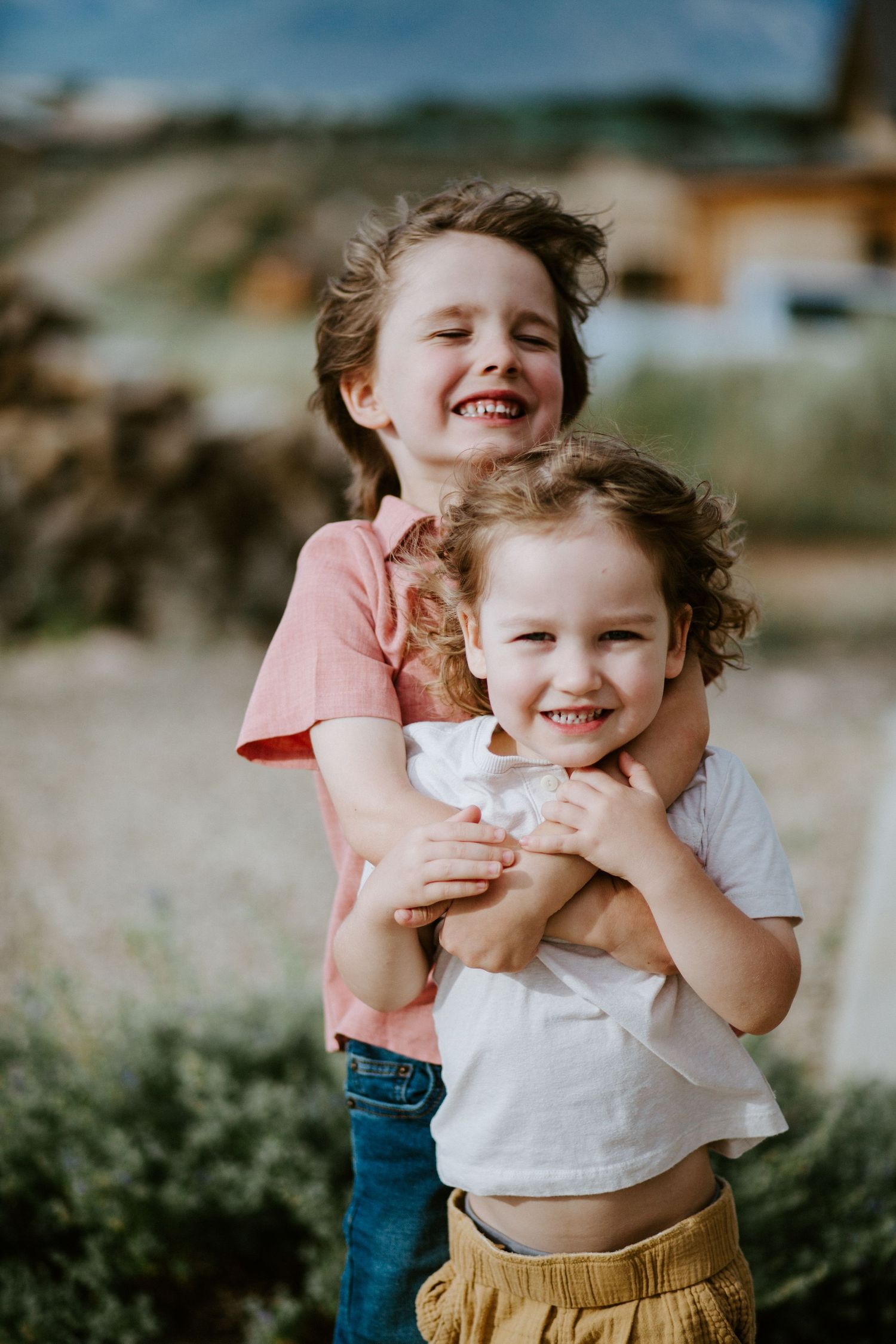 A playful sequence of candid moments captured outdoors showing joyful expressions and embraces.