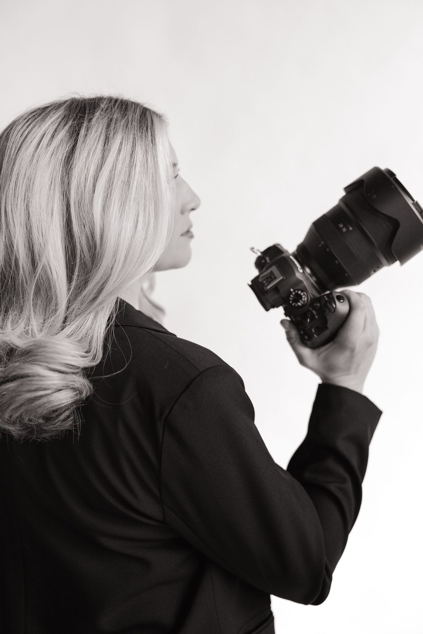 Artistic sequence of photographer holding camera in black and white profile shots.