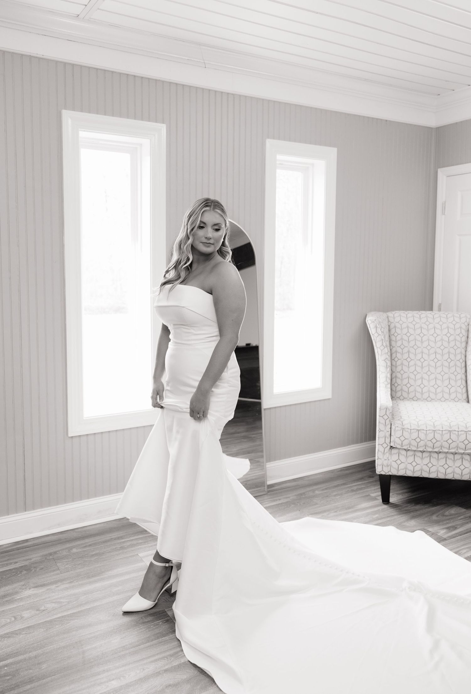 A black and white wedding photography sequence showing a flowing white bridal gown in an elegant empty room.