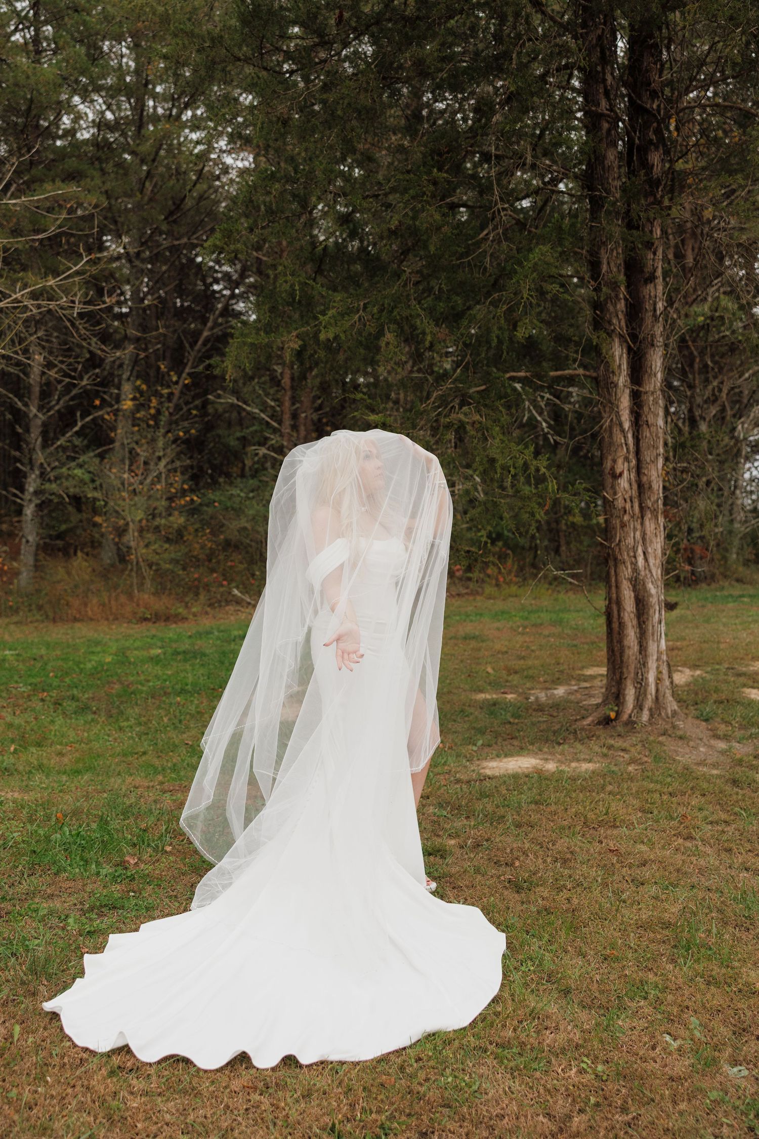 Flowing white wedding dress and veil captured in sequence against wooded outdoor setting.