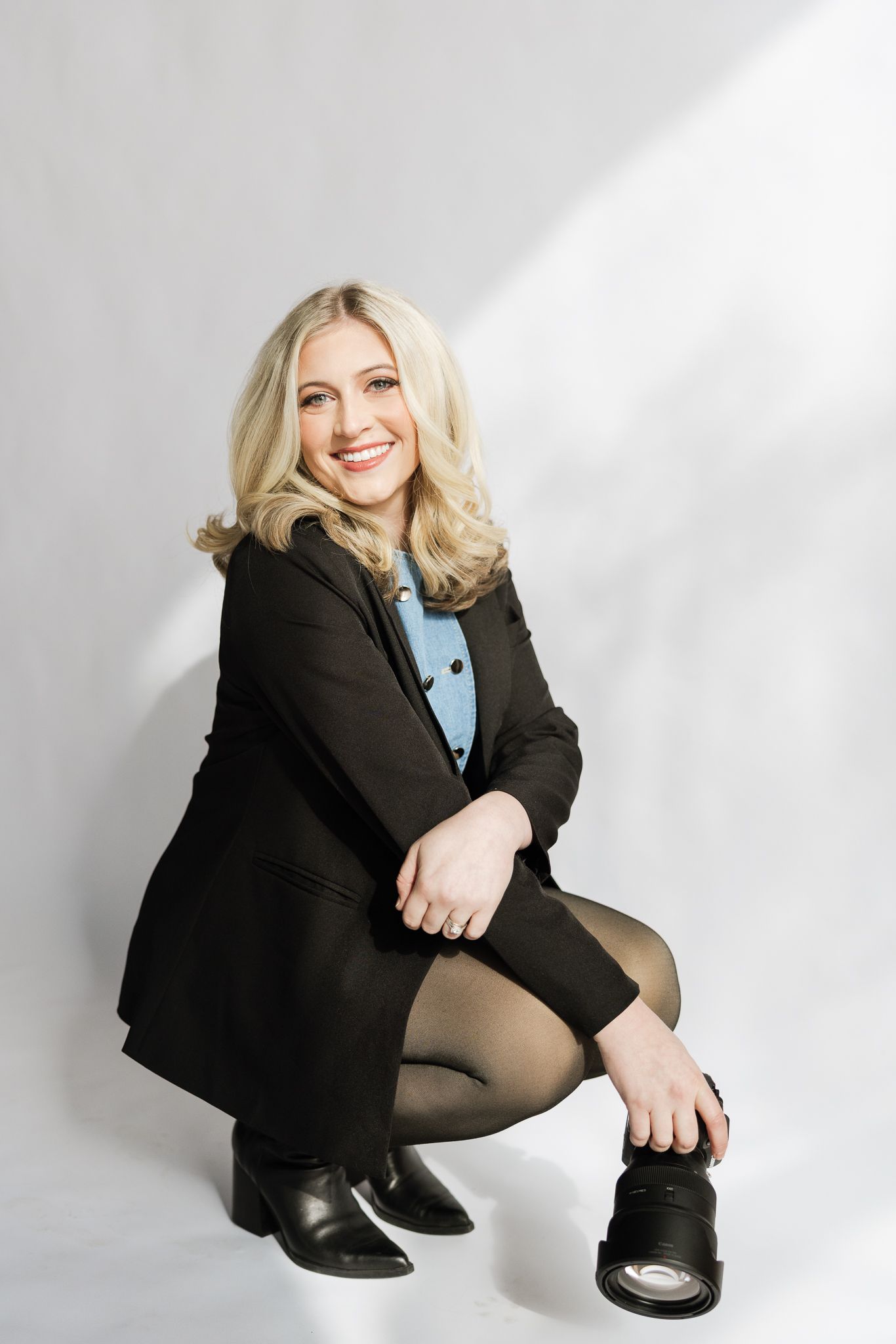 Professional studio portrait against white background with dramatic lighting.