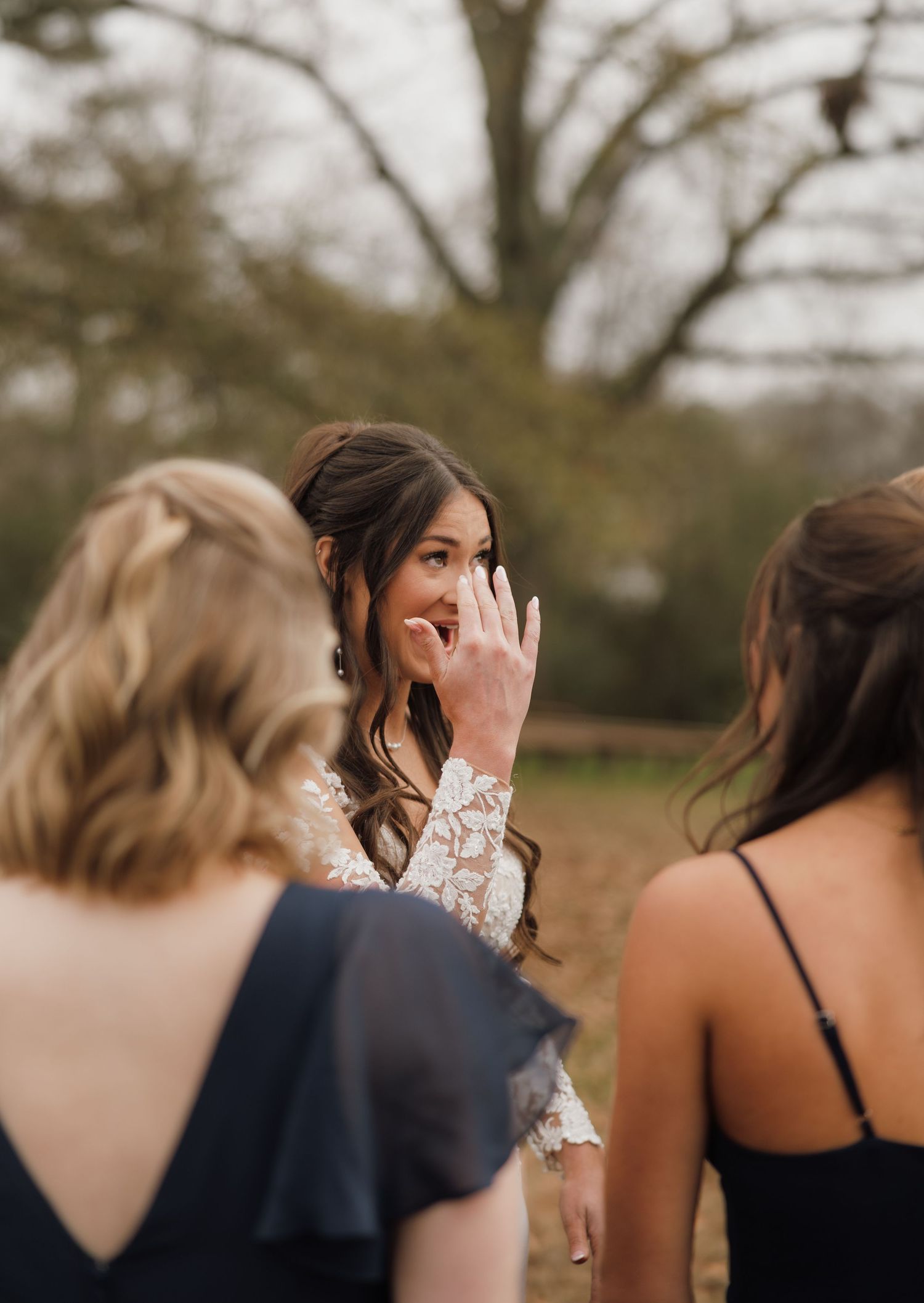 Emotional wedding party moment captured outdoors during sunset.