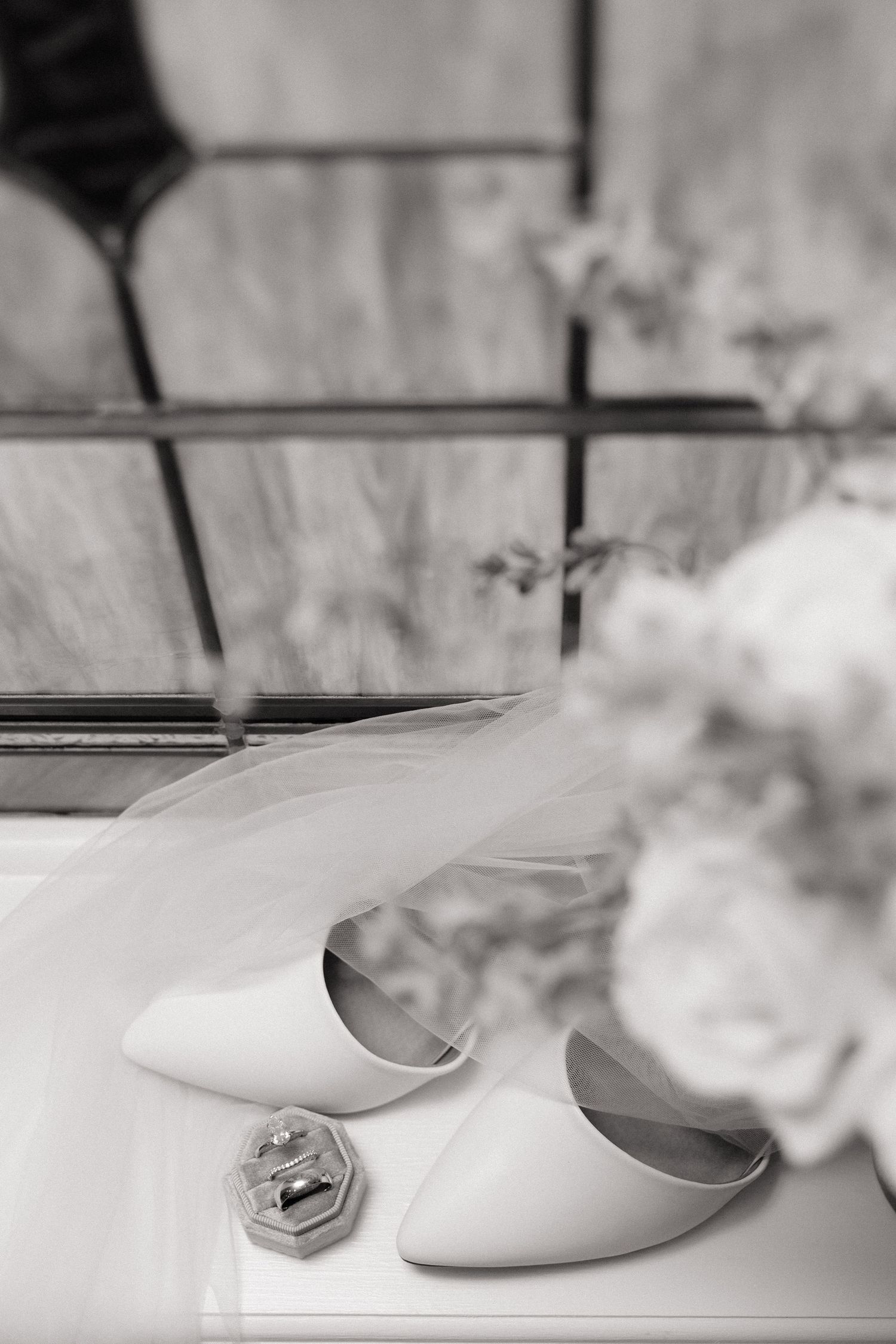 White ballet slippers arranged in a row against a light background create an elegant artistic composition.