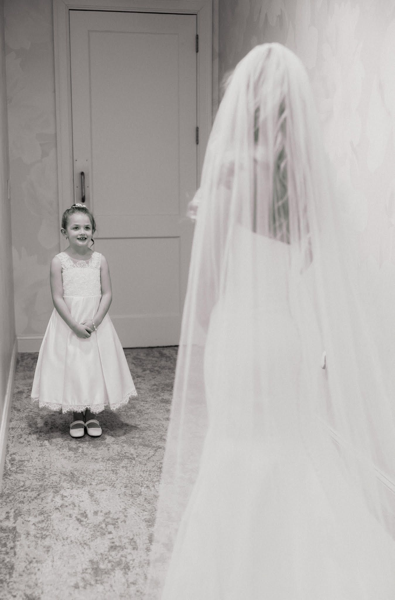 Wedding preparation scene with flowing white veil in elegant indoor setting.
