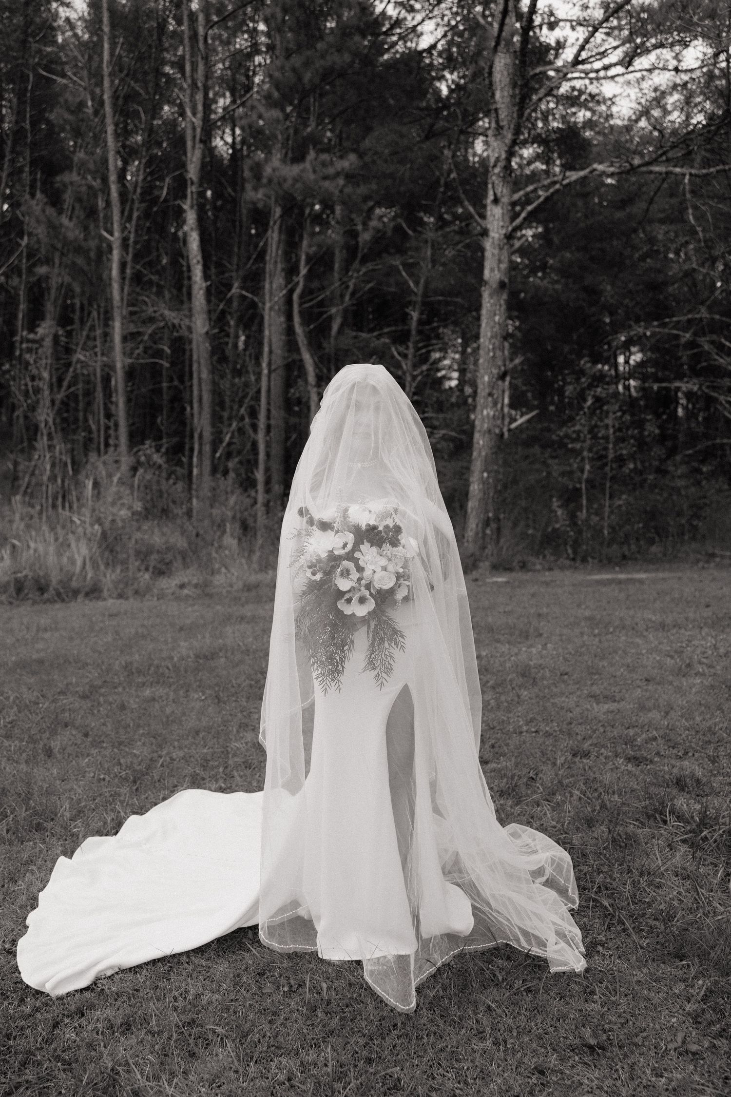 Artistic black and white photo series of flowing wedding veil in a forest setting.