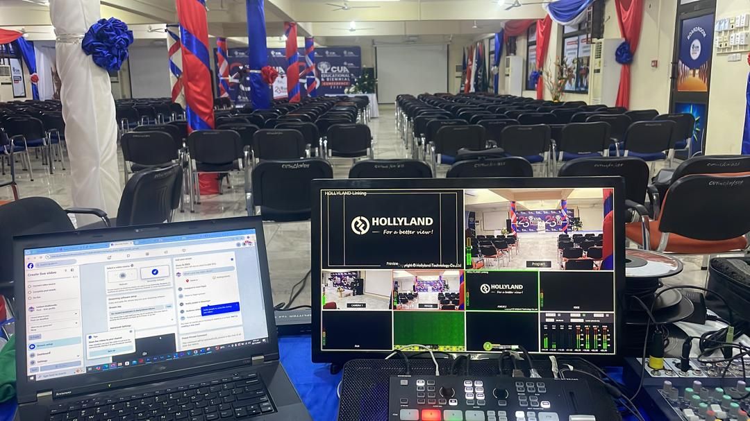 Hollyland video switcher setup with monitors and laptop at a live event production station.